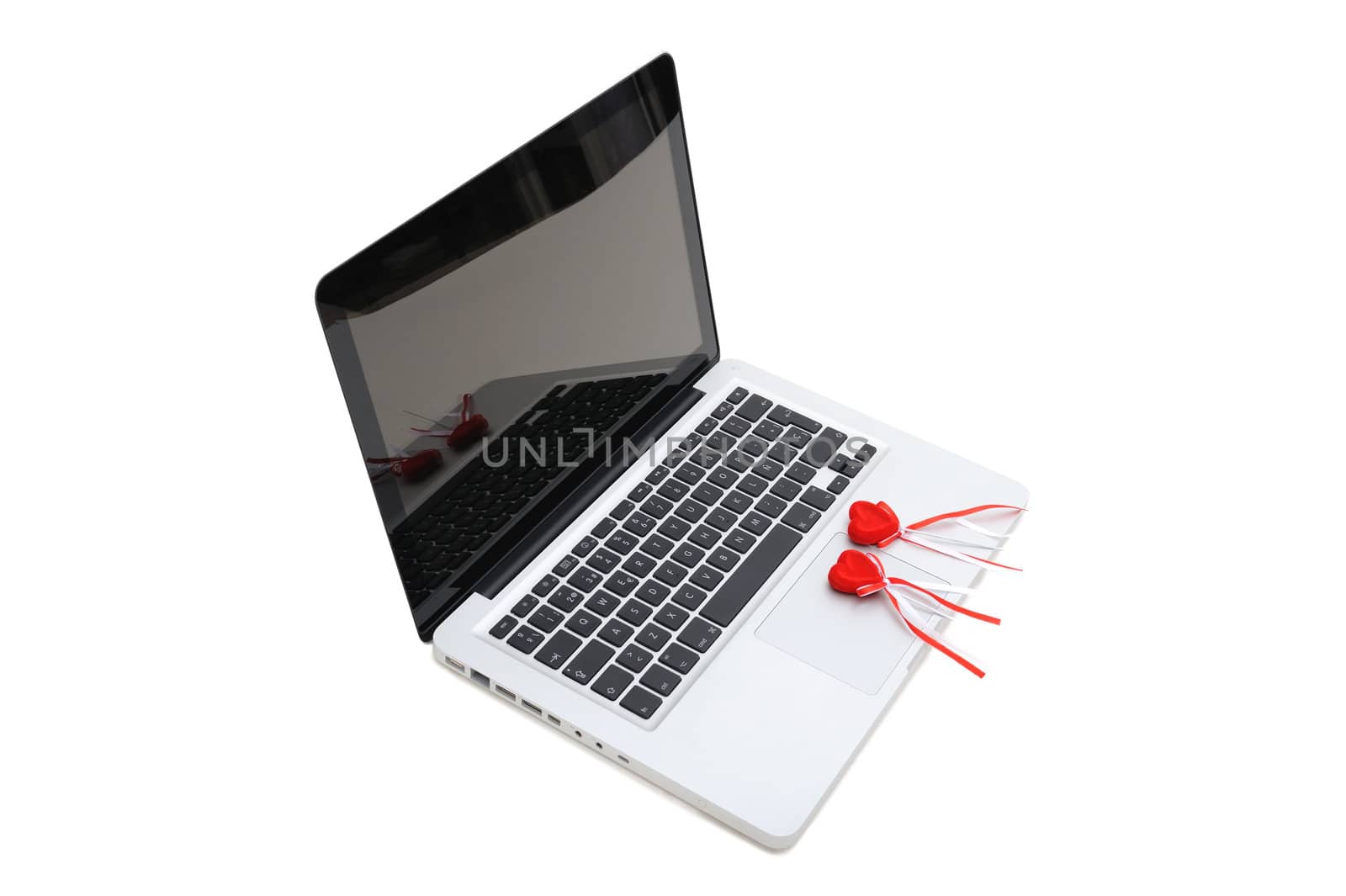 Notebook with two plush red hearts on keyboard by DrVIB
