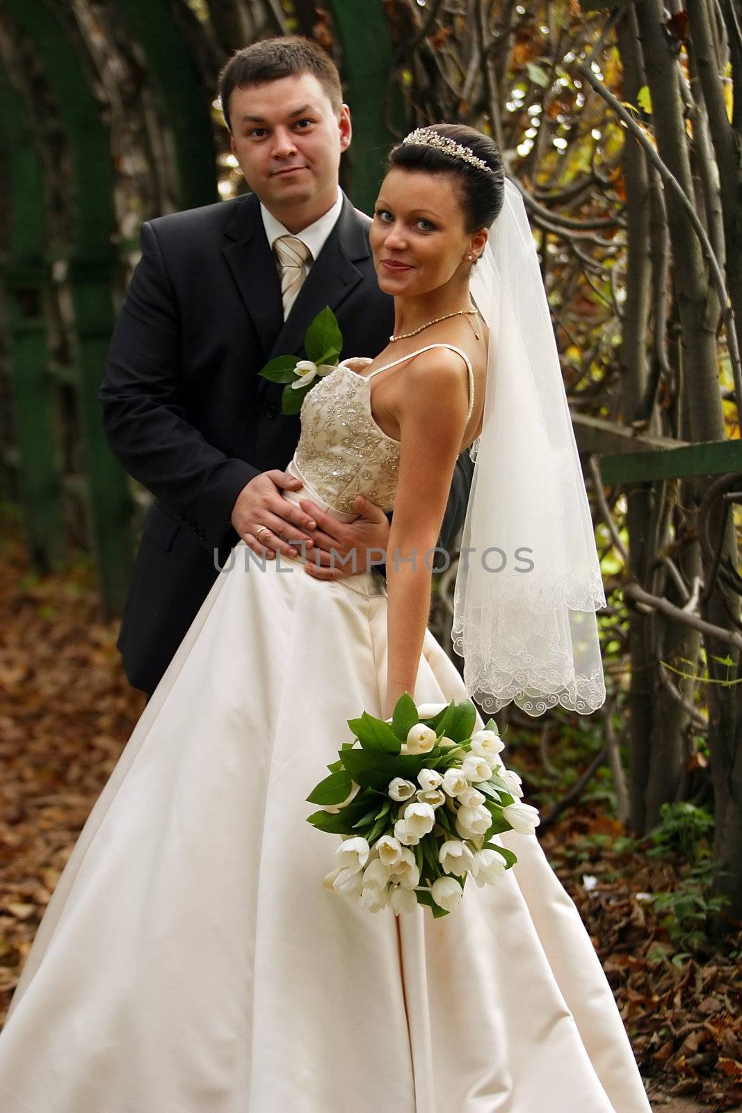 Beautiful the bride and the groom in autumn park
