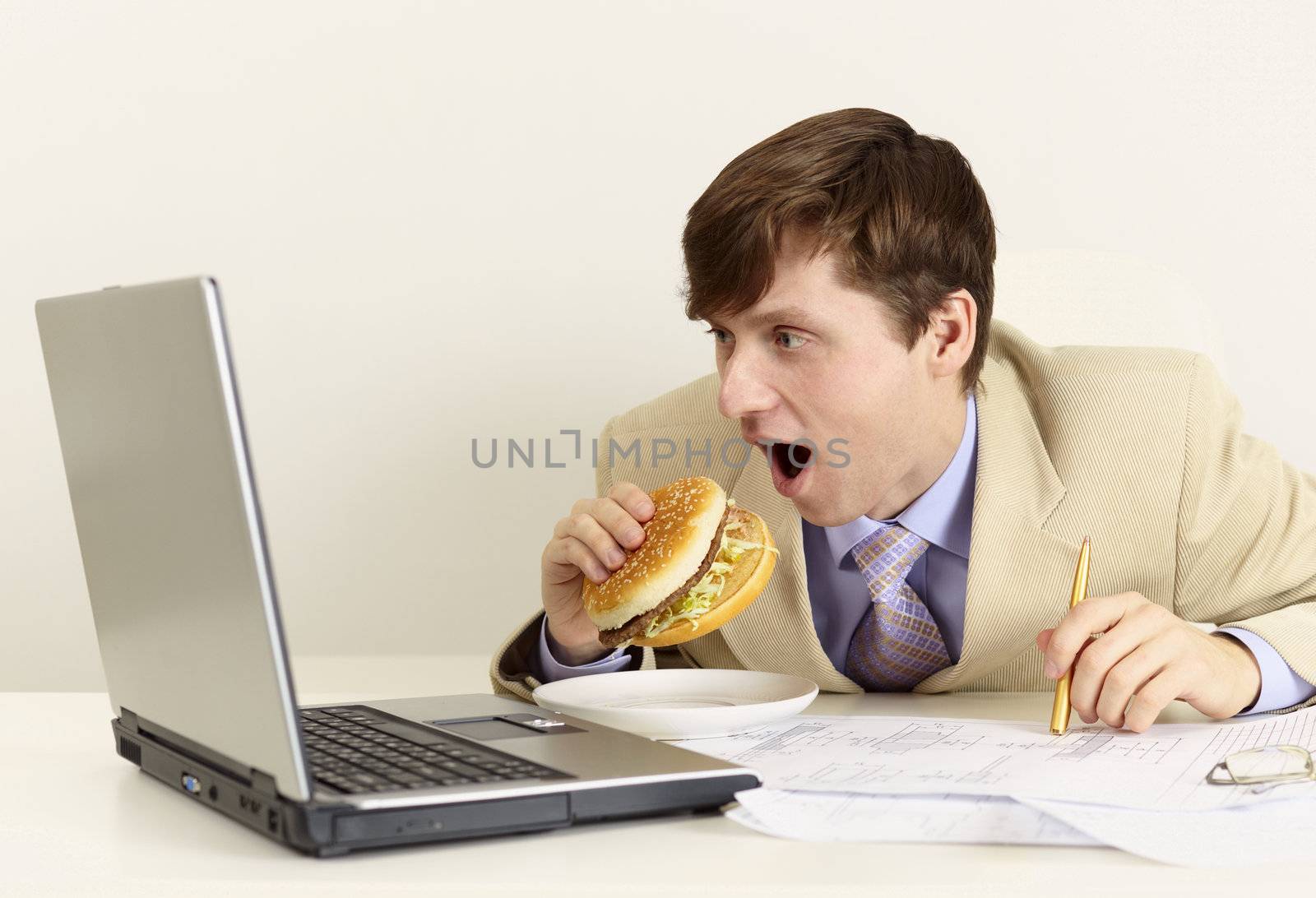 Young businessman is going to eat sandwich by pzaxe