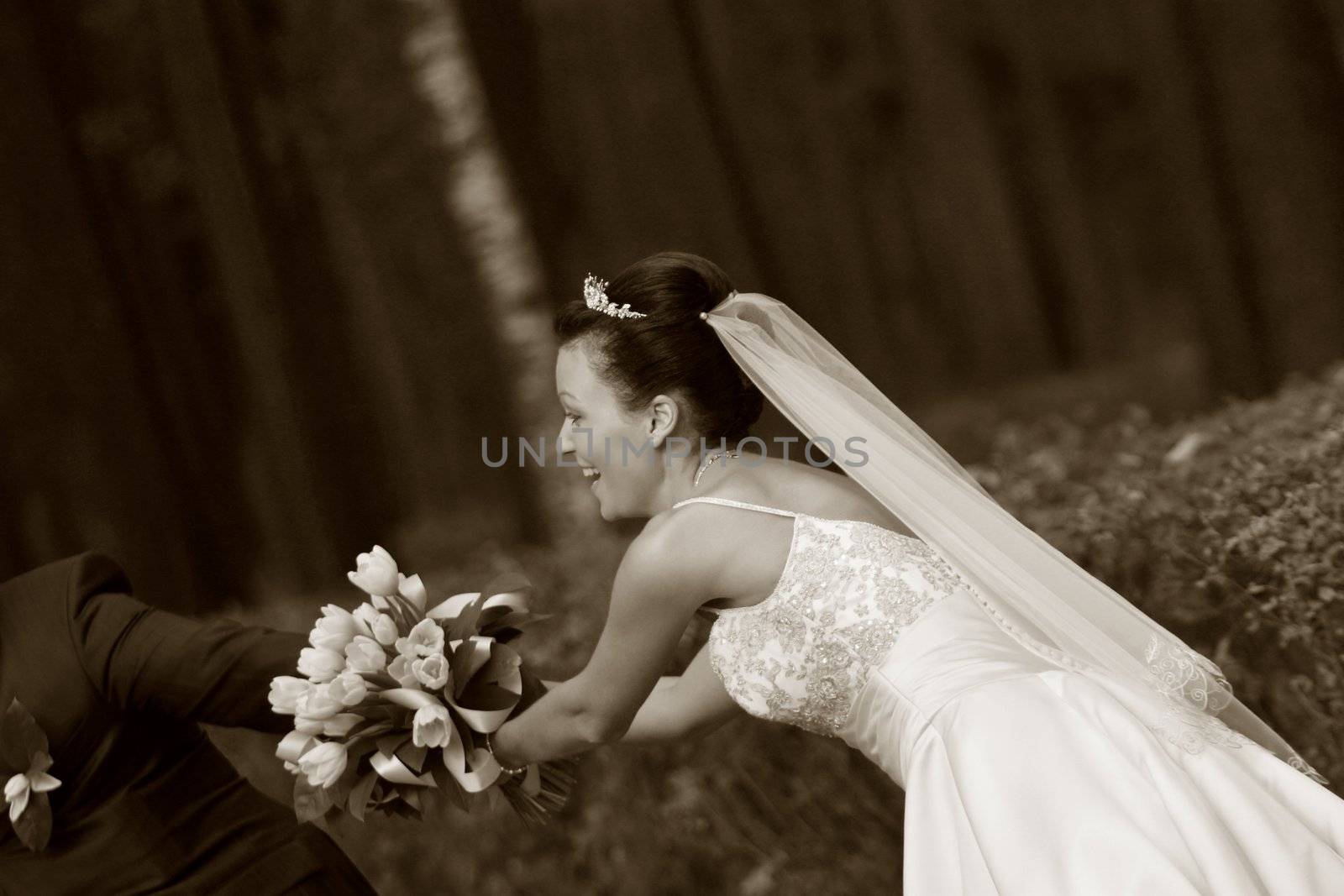 Beautiful the bride and groom with a bouquet from tulips in park