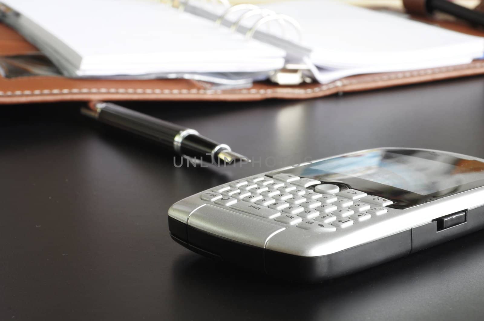 working in an office with calculator phone and organizer