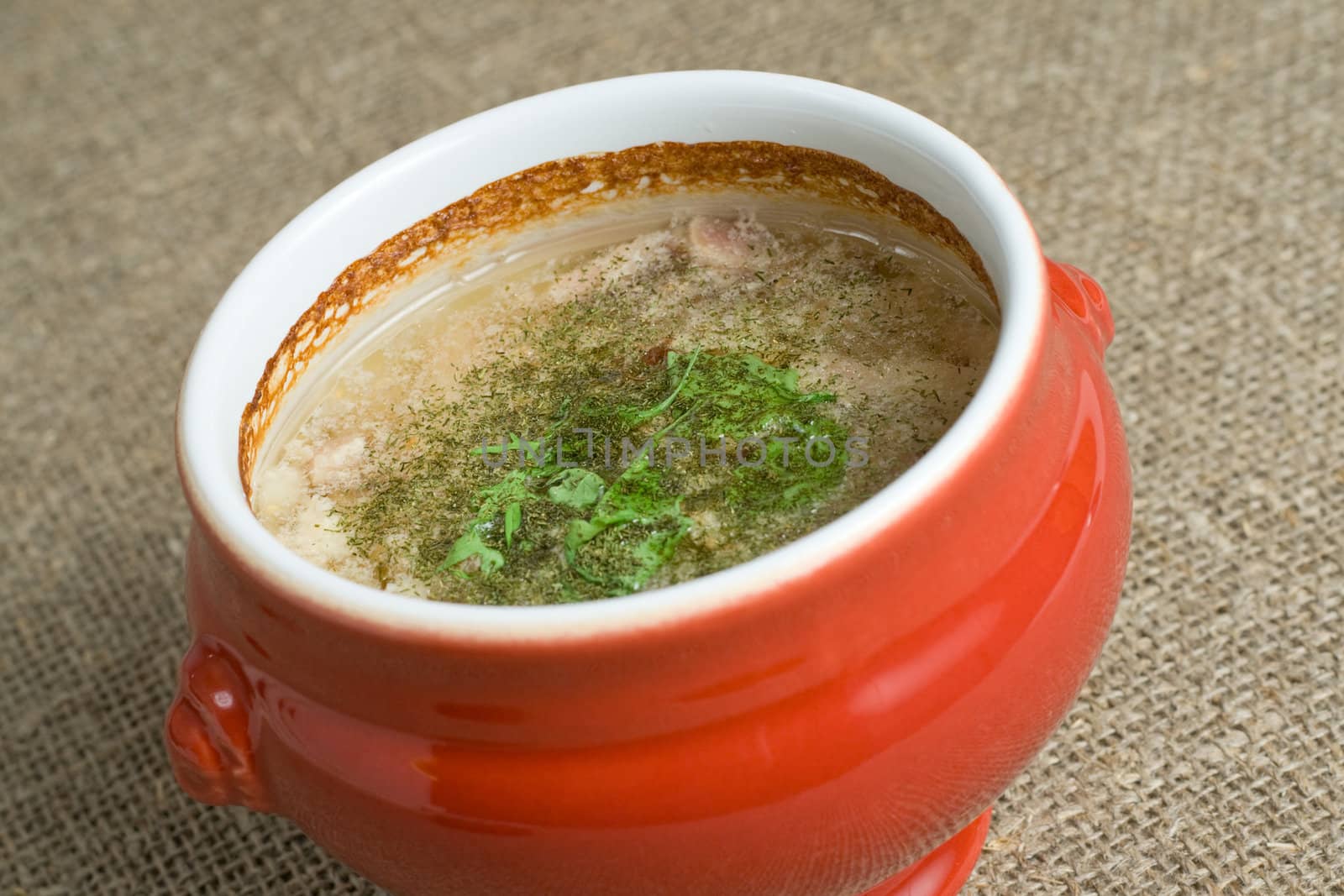 soup served in a ceramics pot, shallow DOF