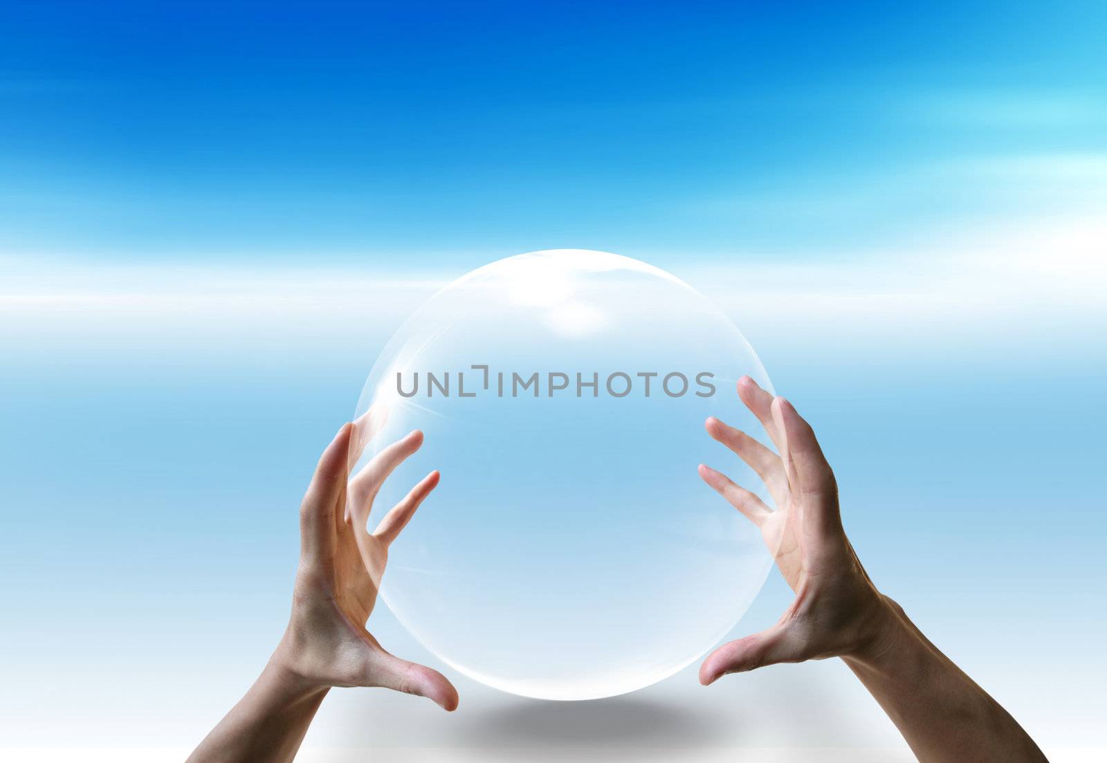 Two hands and a big bubble on the blue sky background