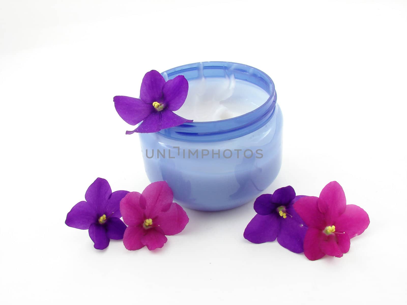 Violets, flowers and cream isolated over white background, concept of beauty.