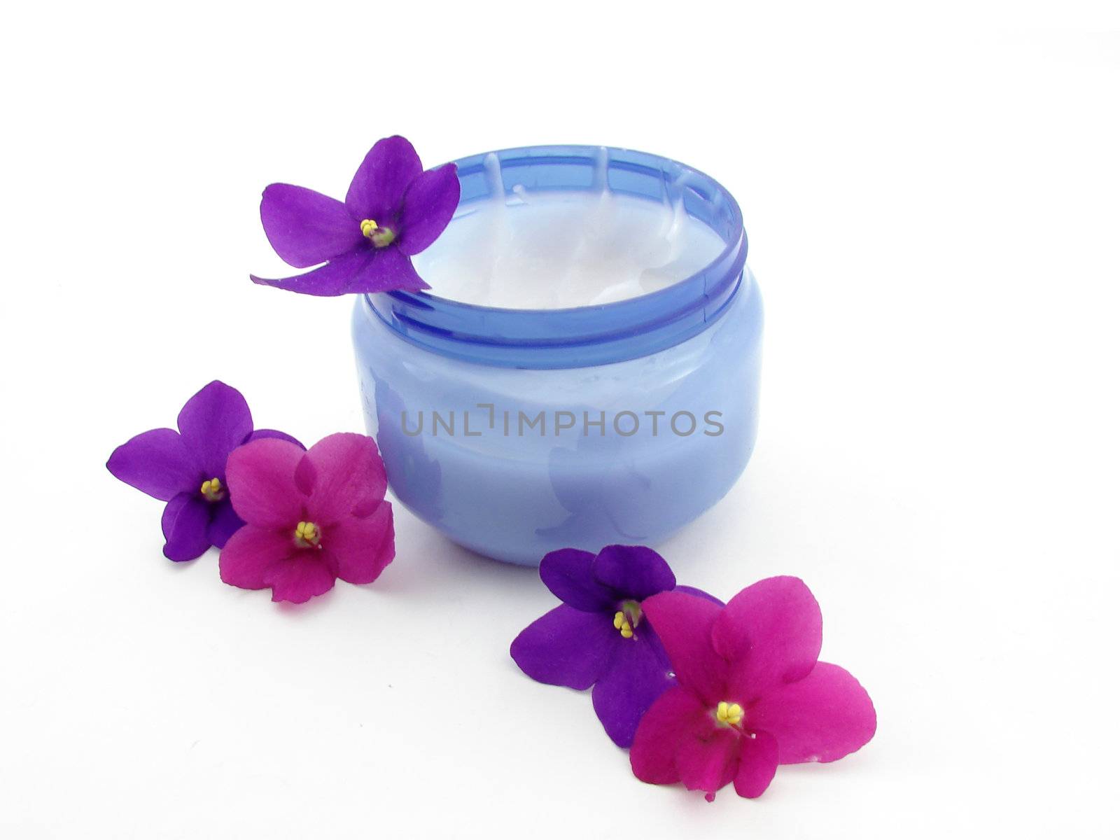 Violets, flowers and cream isolated over white background, concept of beauty.