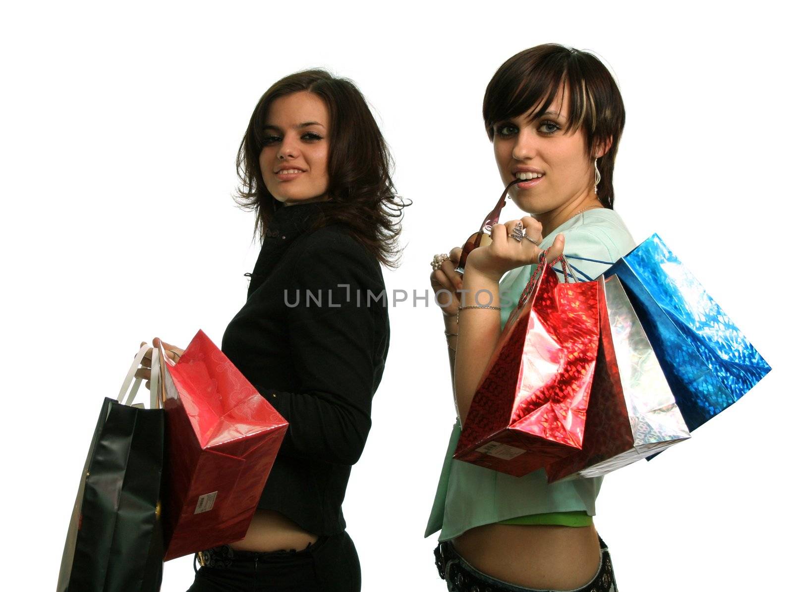 The happy girls with purchases, on a white background 