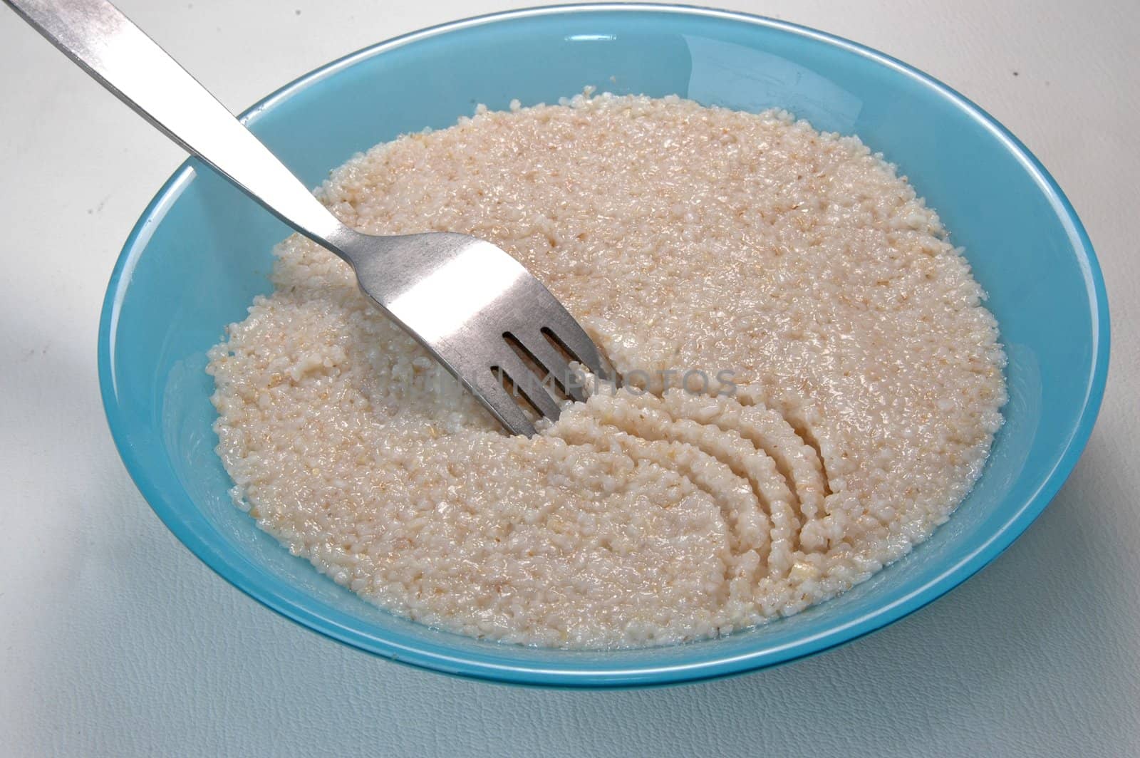 groats porridge in  plate on white