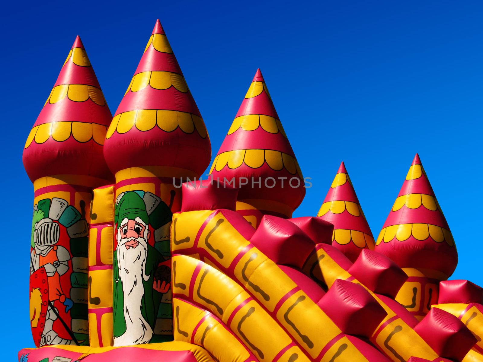 Children's bouncy castle detail, against a summer's clear deep blue sky