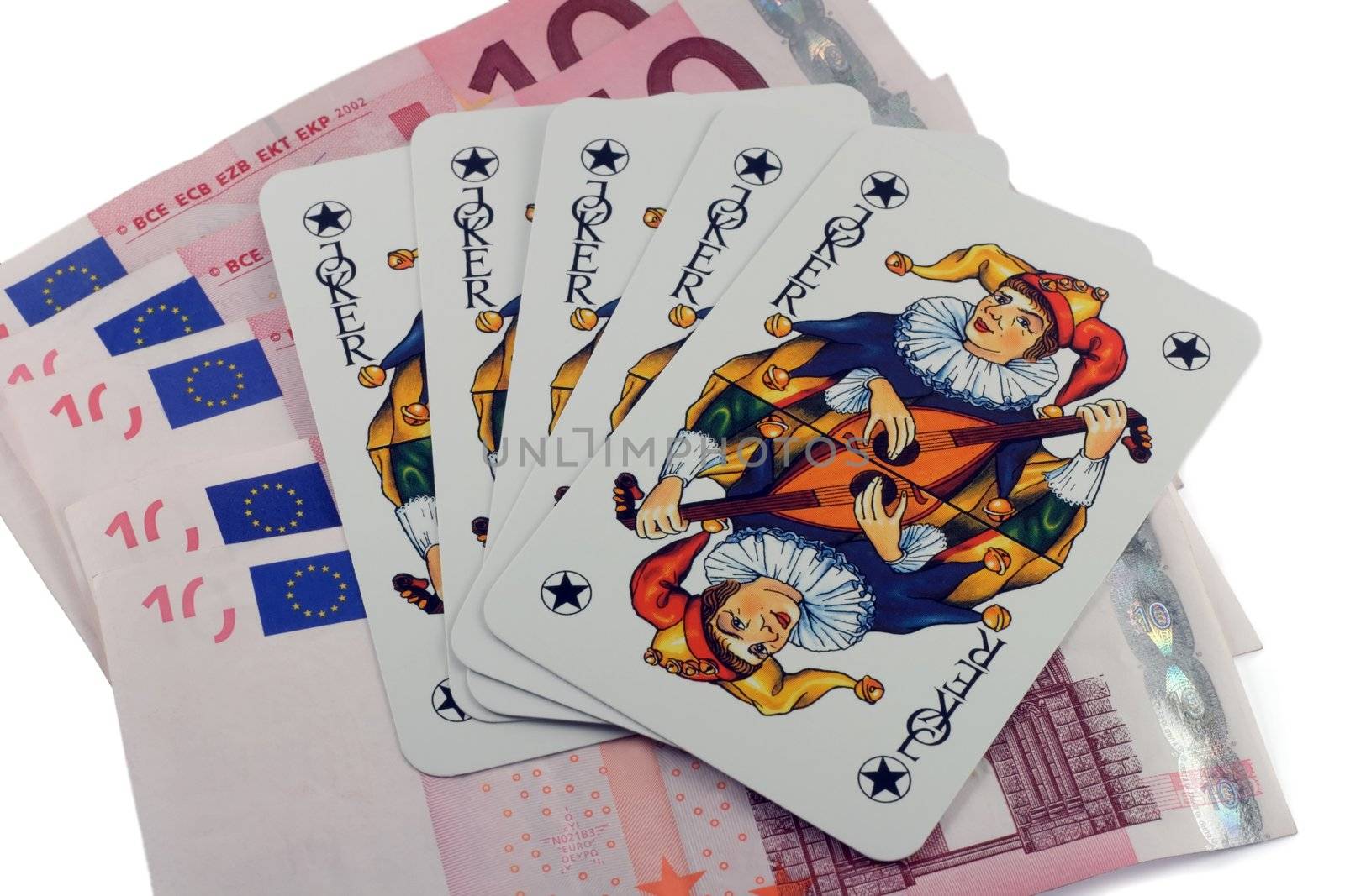 Five card jokers are resting on 10 euro bills.
isolated on a white background