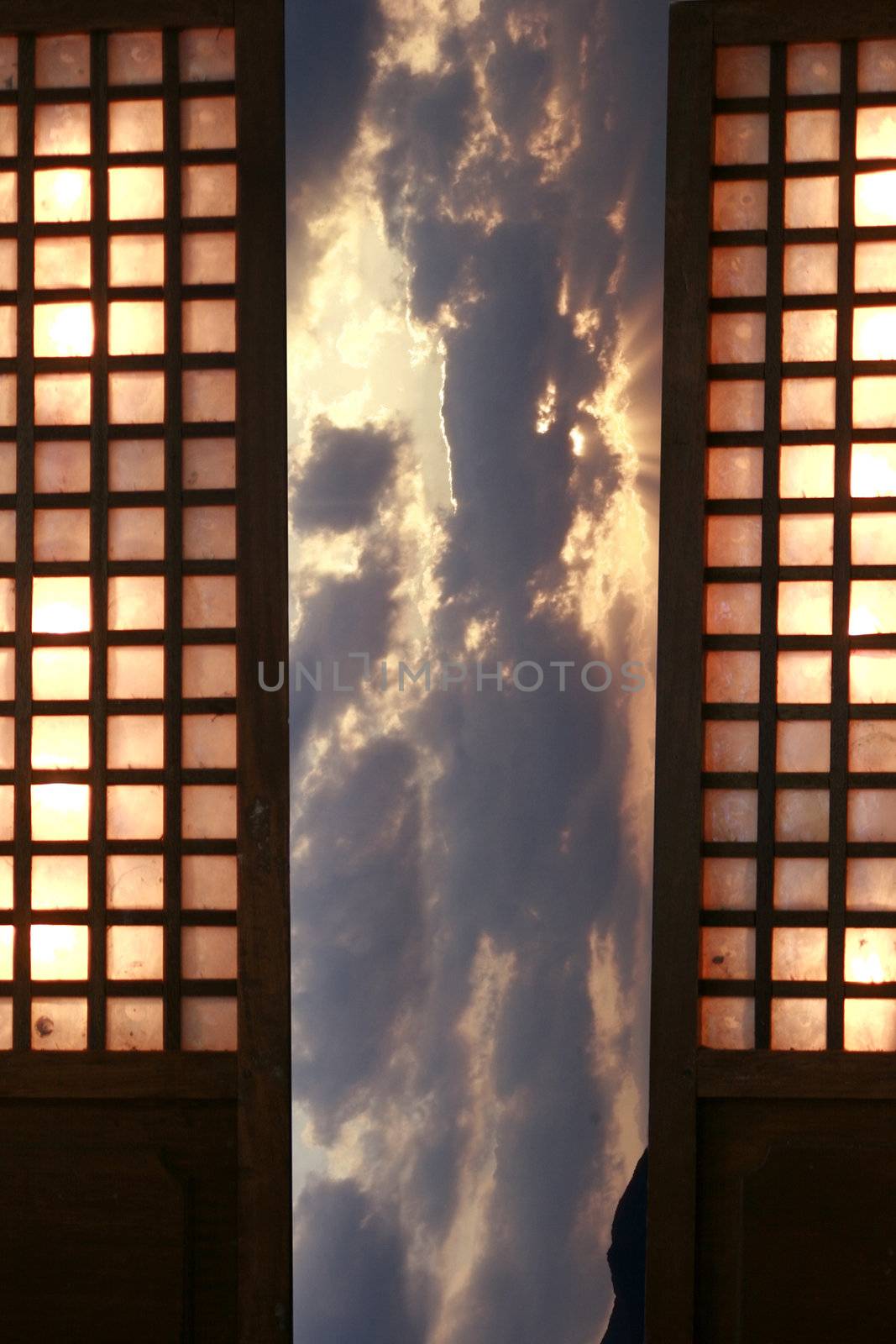 Traditional windows mada of sea shell with dramatic sunset background