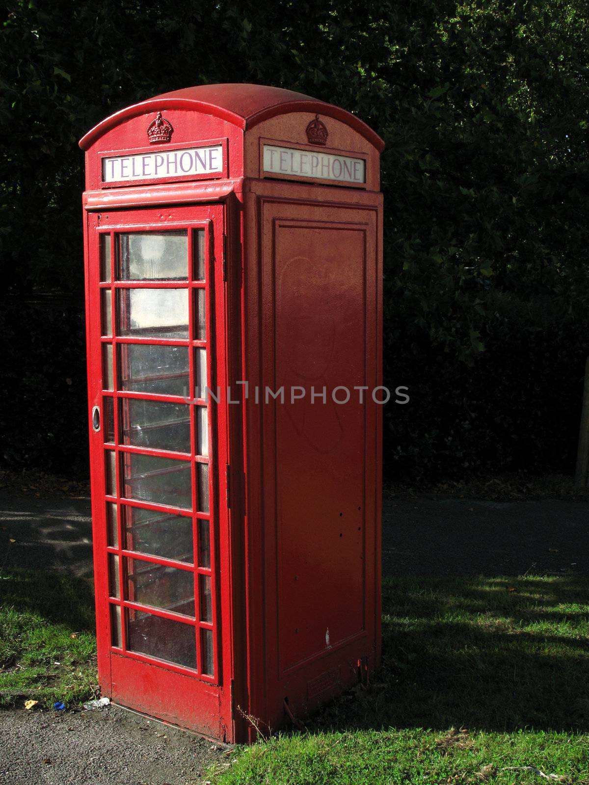 Traditional British telephone kiosk in urban setting