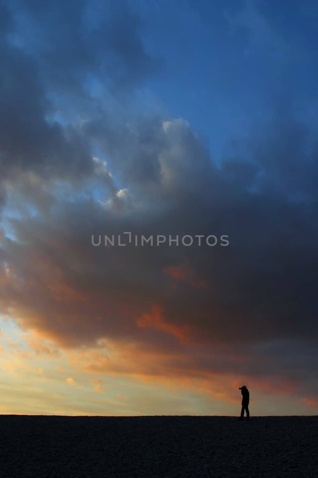 Beautiful sunset sky with man silhouette