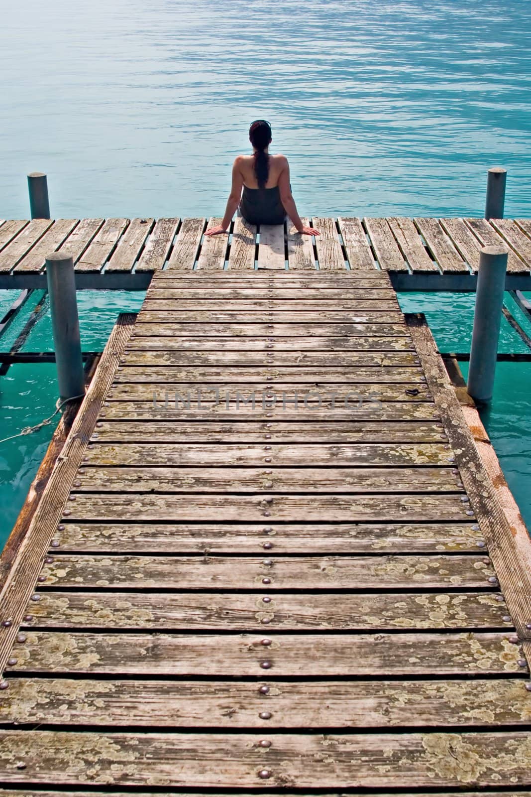 Woman contemplating in wooden dock