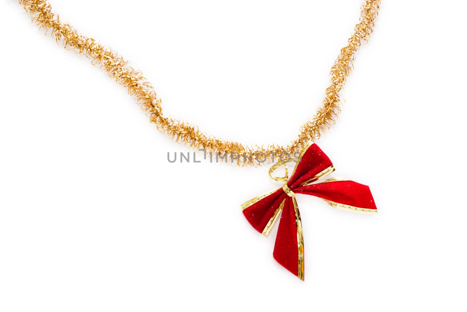 Red christmas bow hang on golden ribbon isolated on white background