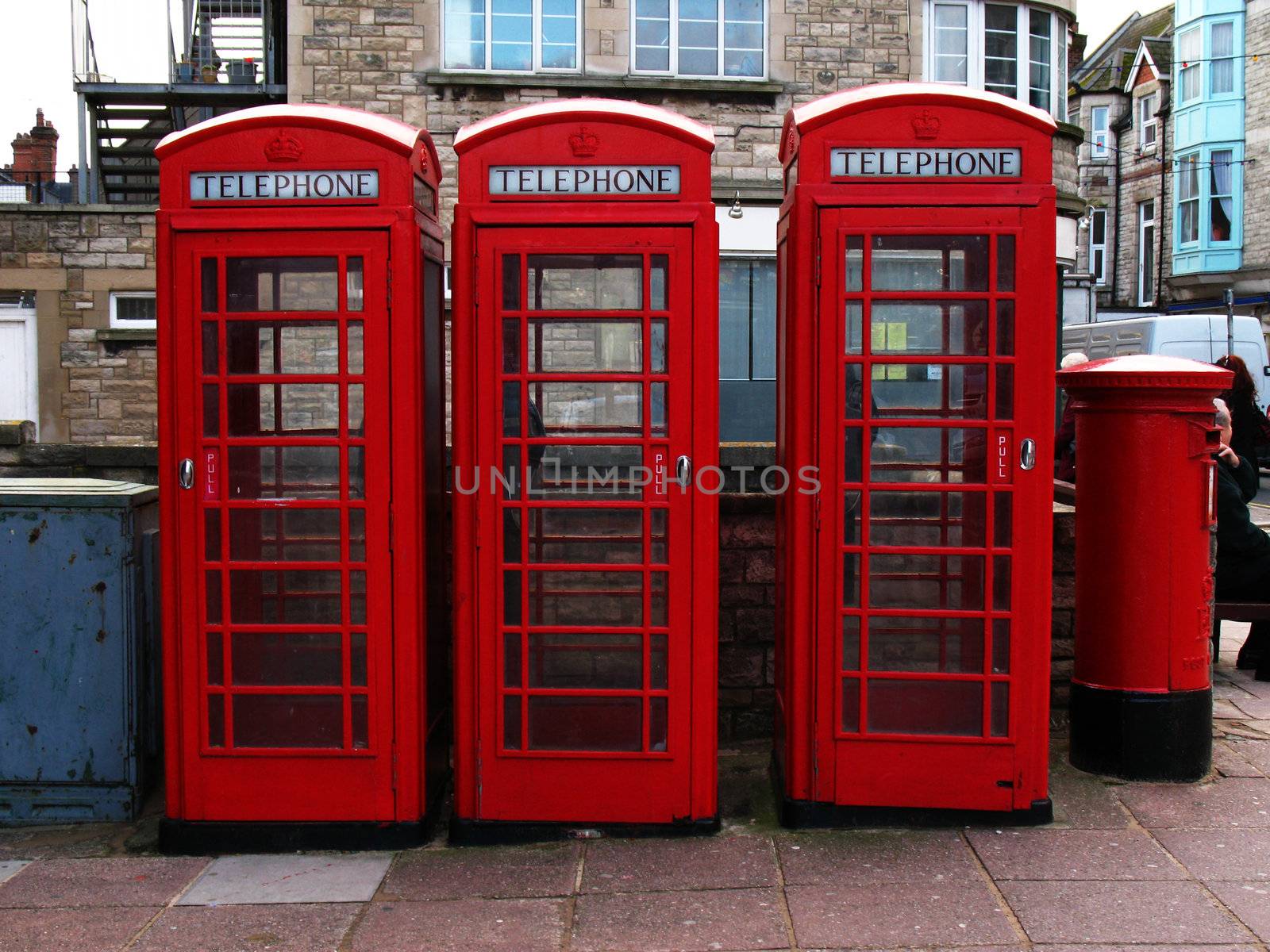 Three telephone boxes and a post box