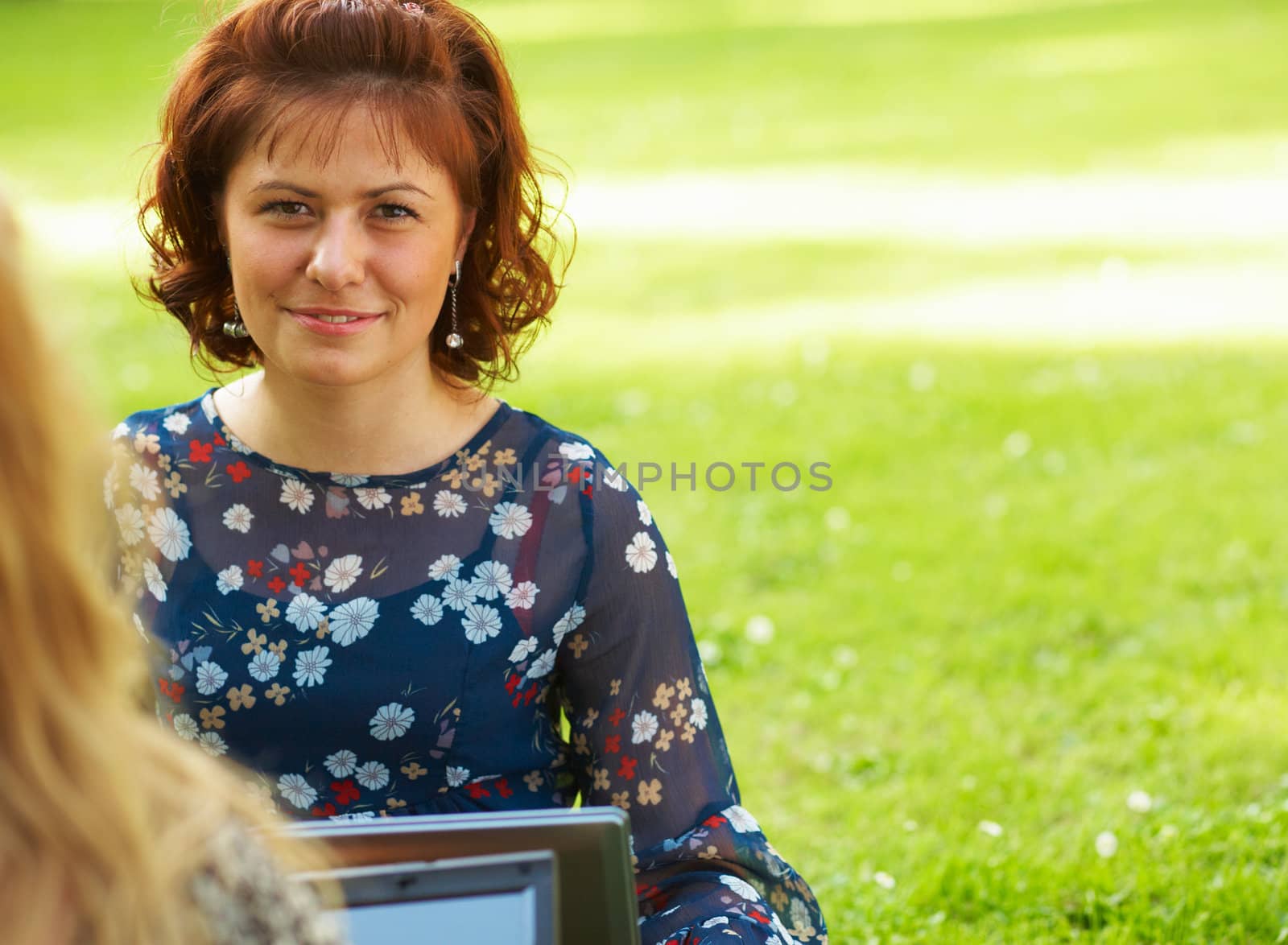 Young woman using her laptop outdoors.