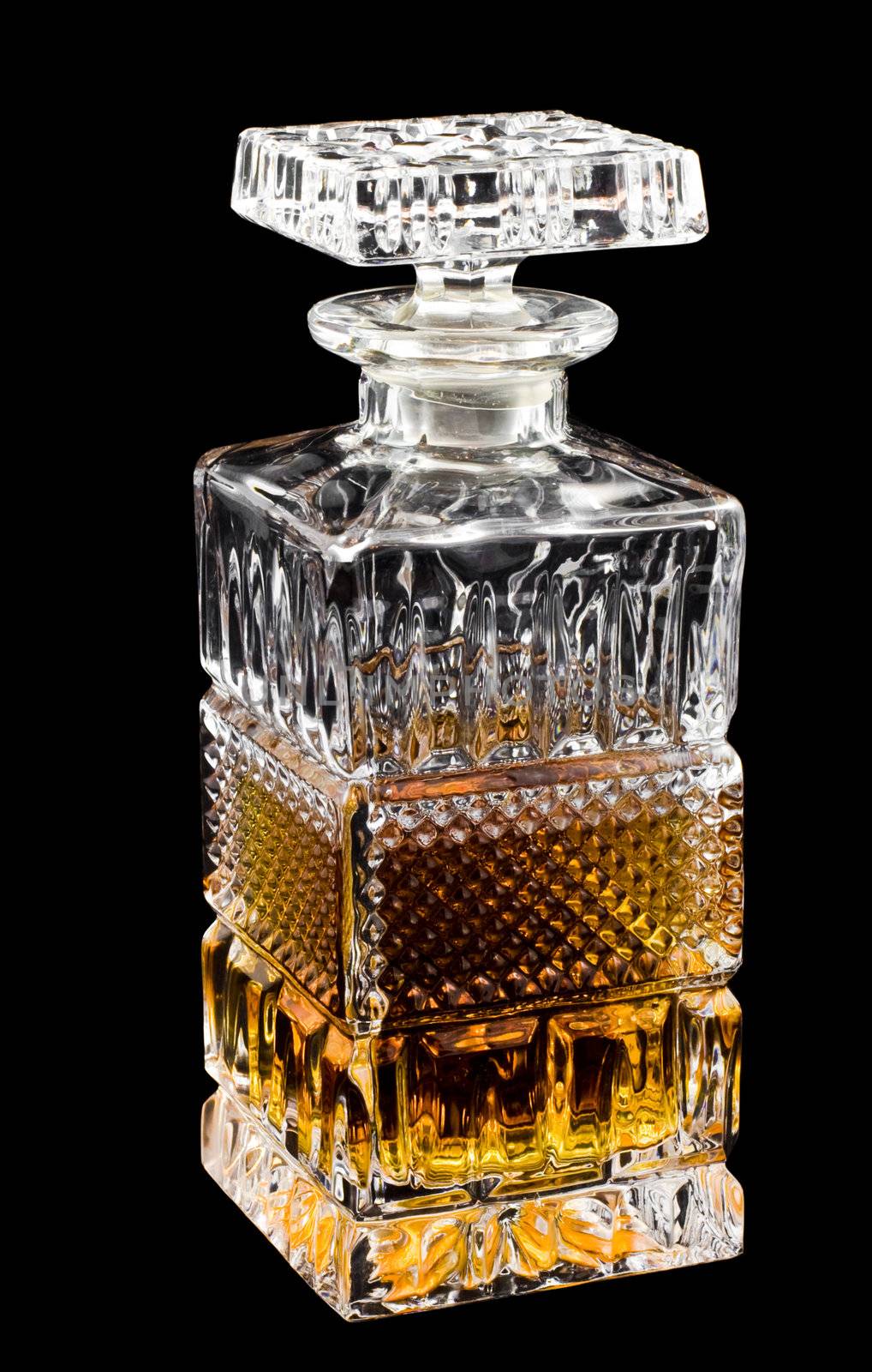 Crystal decanter with whiskey isolated over black