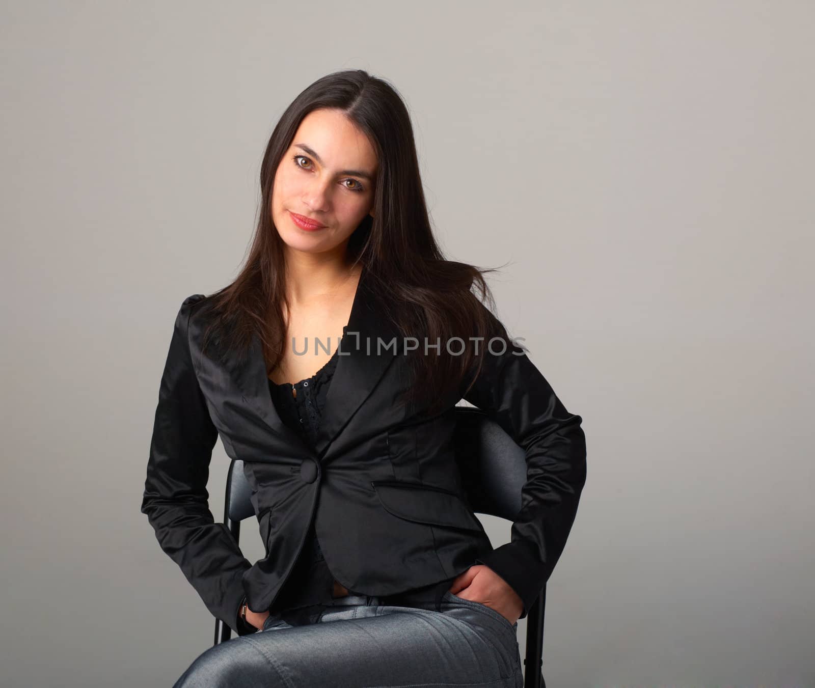 A young attractive woman sitting on armchair