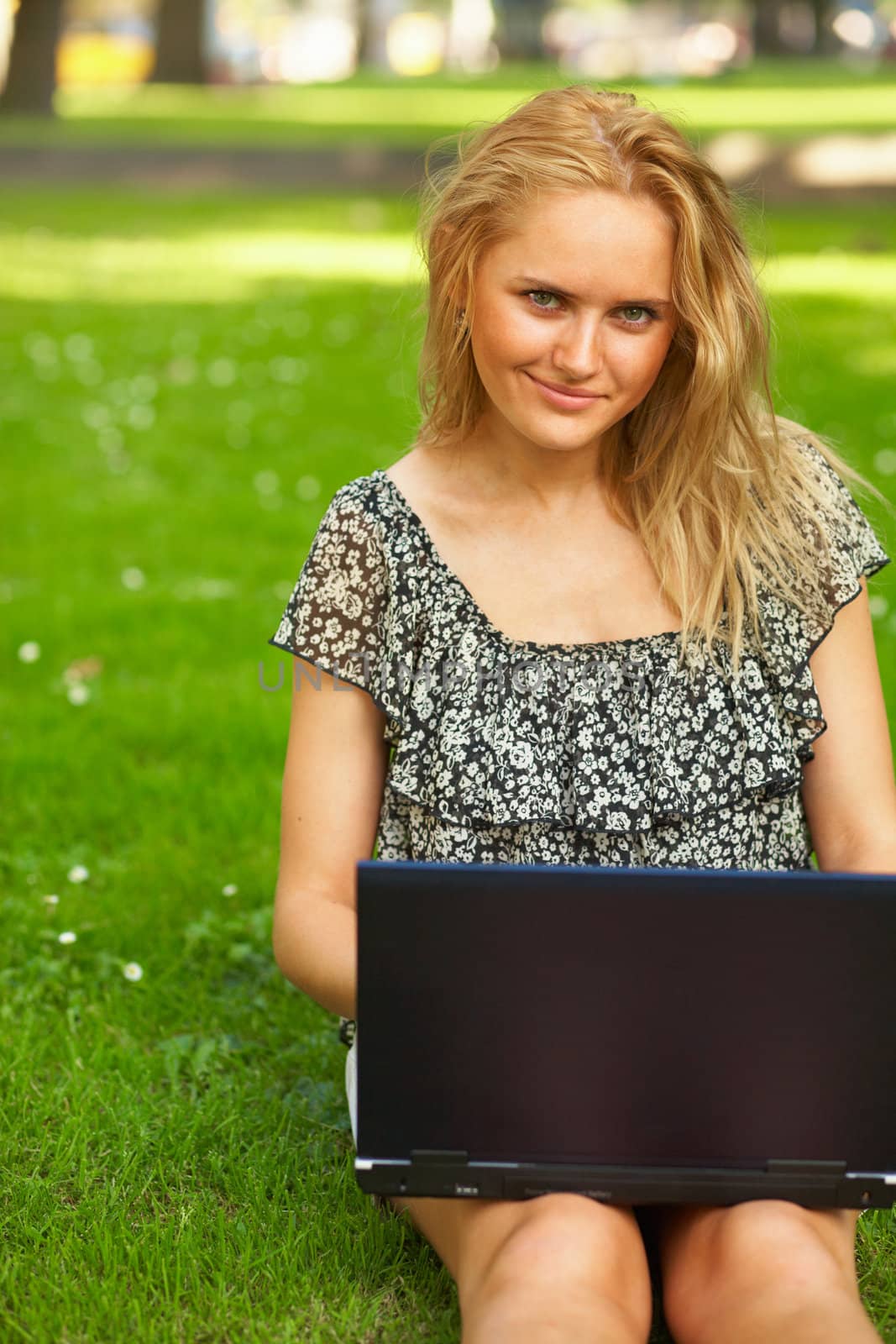 Young woman using her laptop outdoors.
