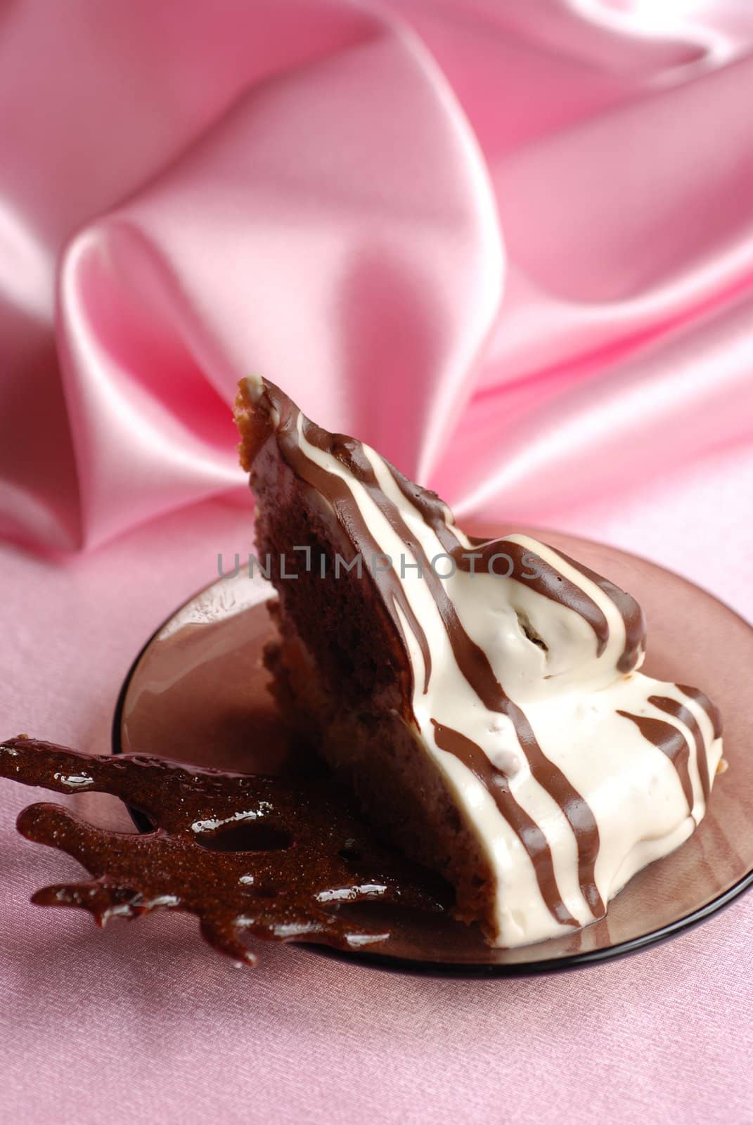 Reace of chocolate cake on a pink background