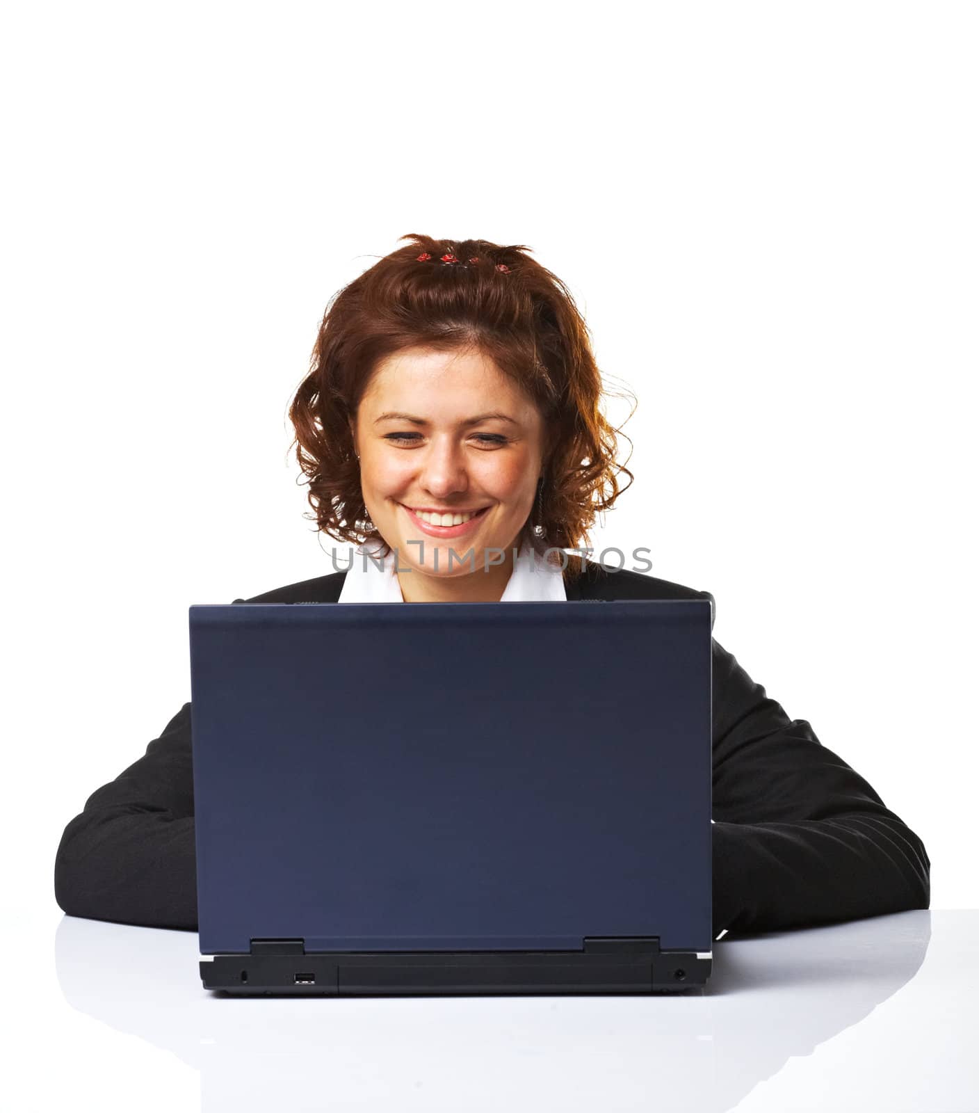 A Happy successful business woman smiling while working on laptop