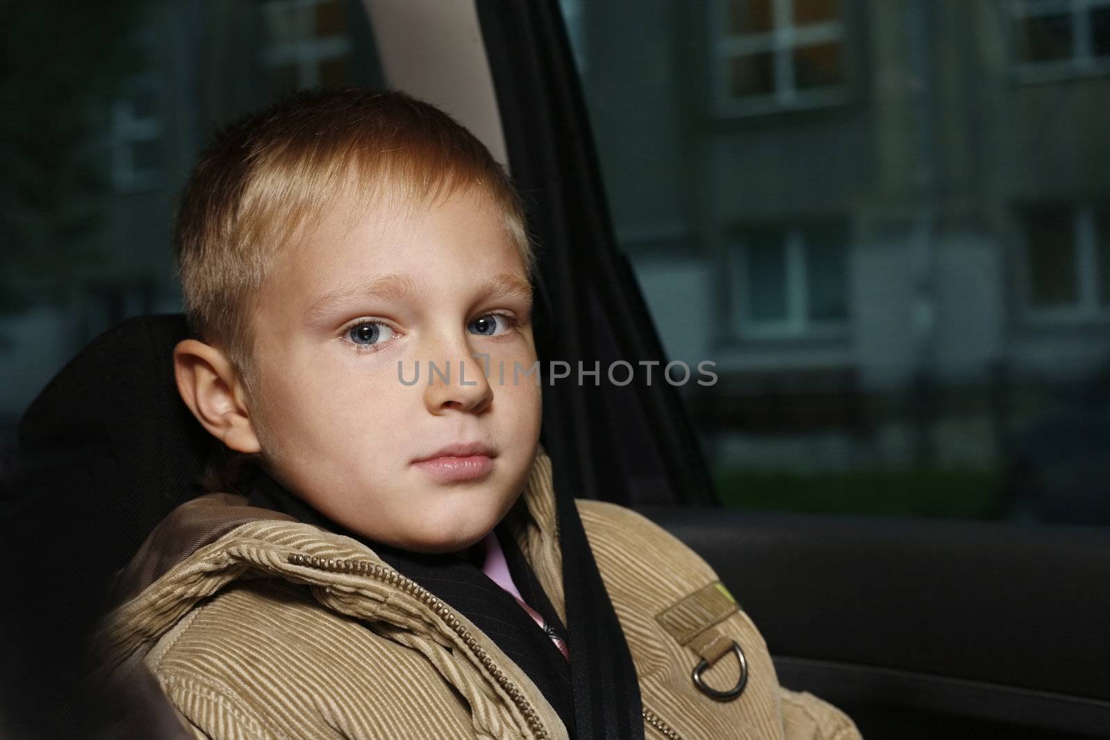 The serious boy in the automobile