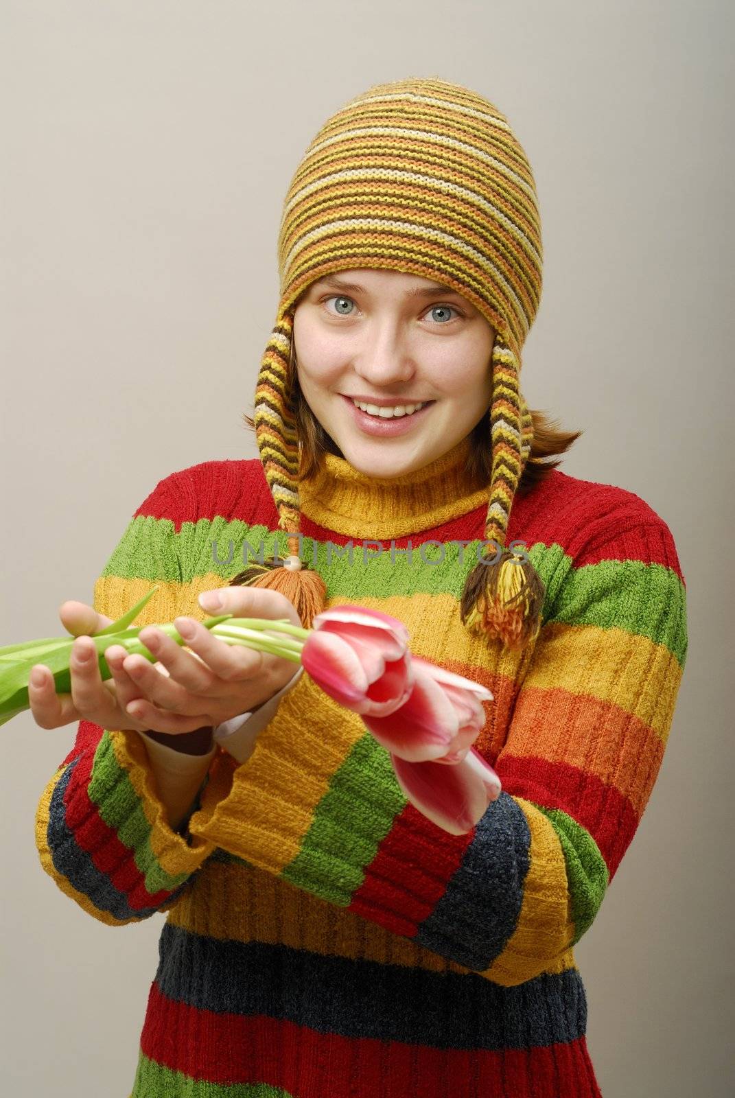 Girl with blue clear eyes holds tulips