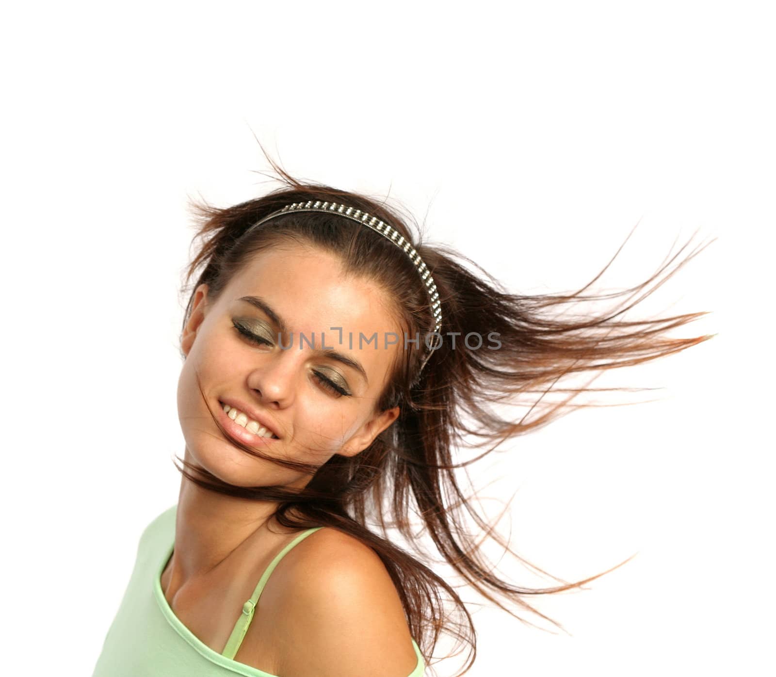 Young brunette girl with a hairdress in movement, isolated on white