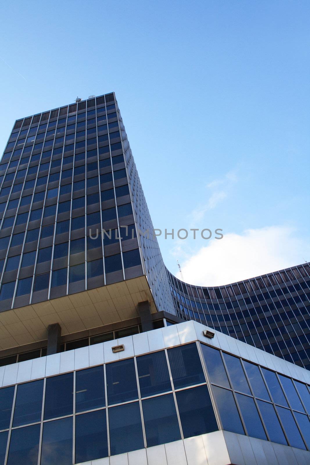 Nice modern glass and steel building on blue sky background