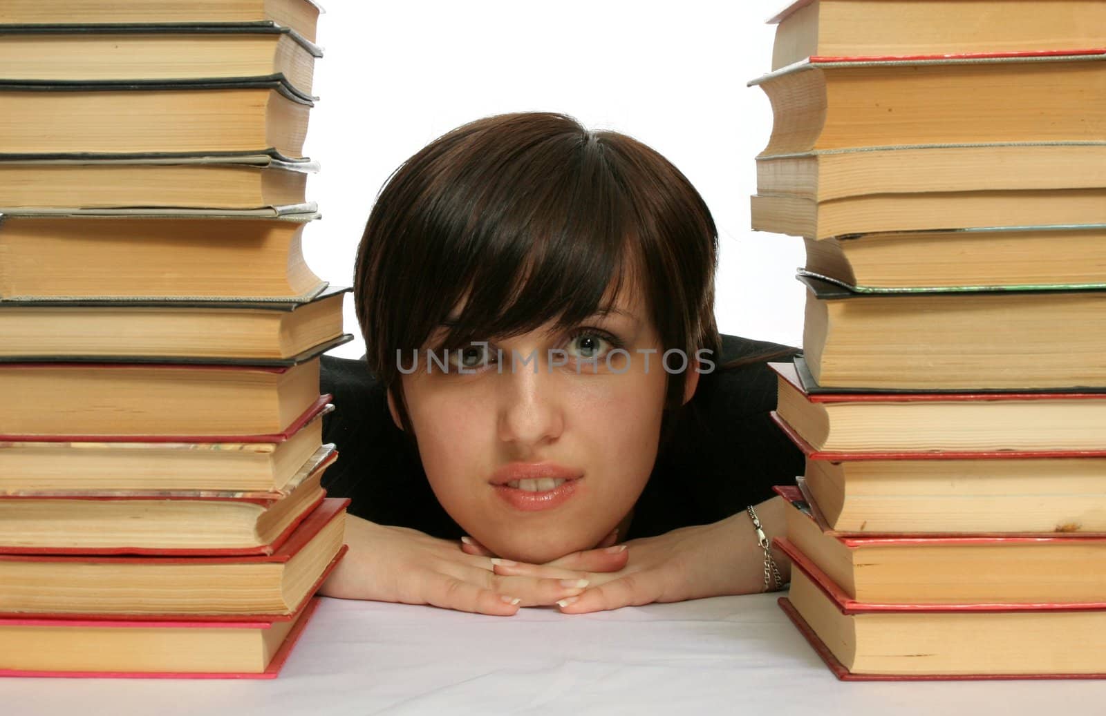 The young smiling girl with books, isolated on white
