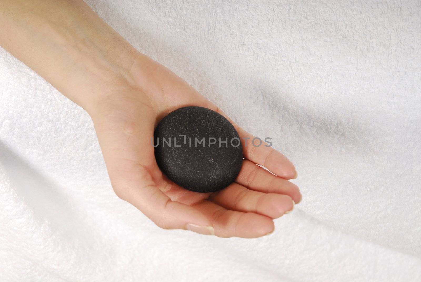 Woman hand with gray stone