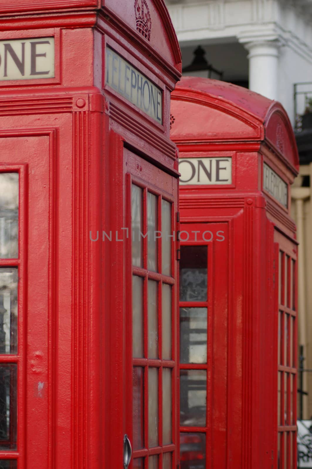 Two old style red UK telephone boxes