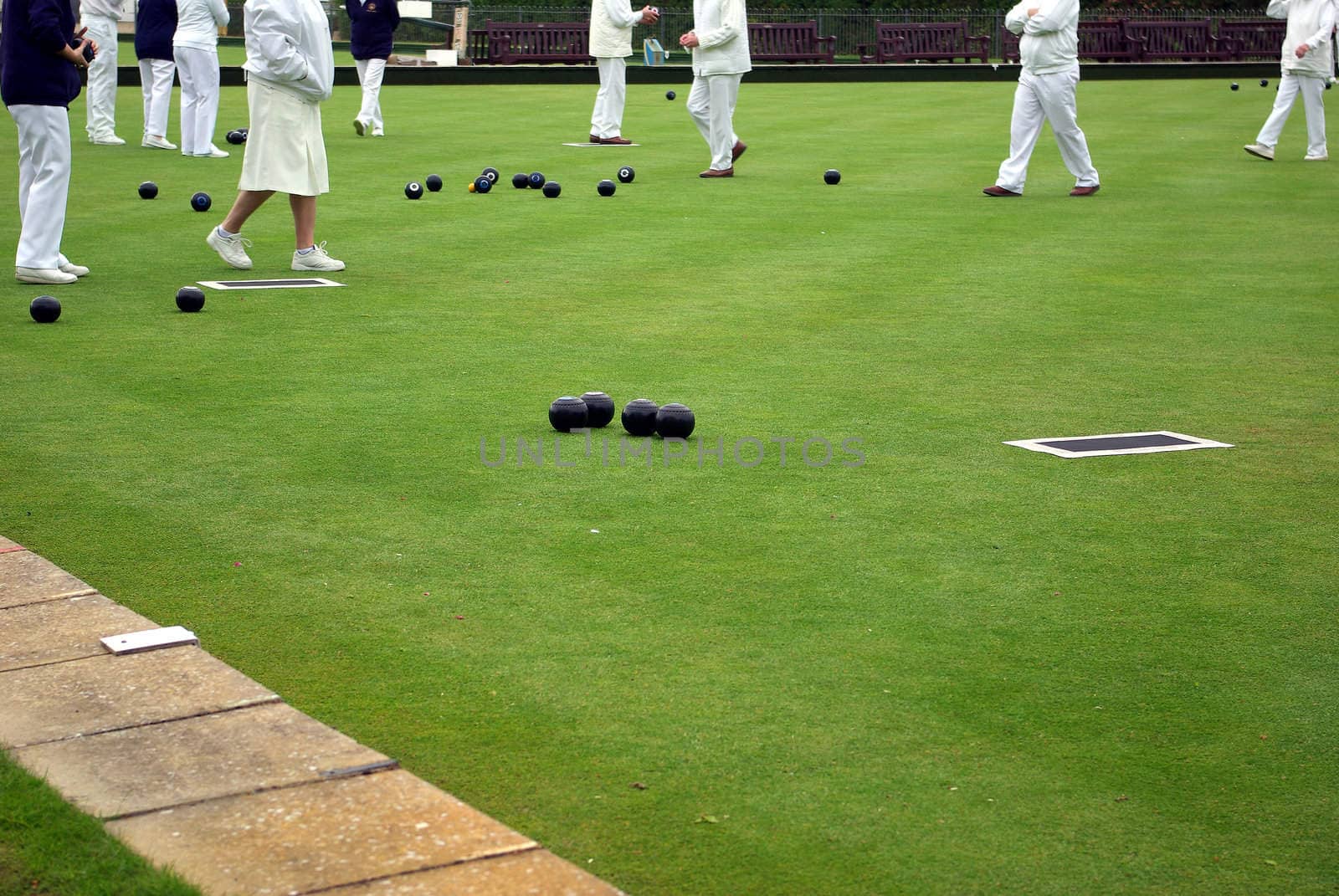 Photo showing senior people playing lawn bowling