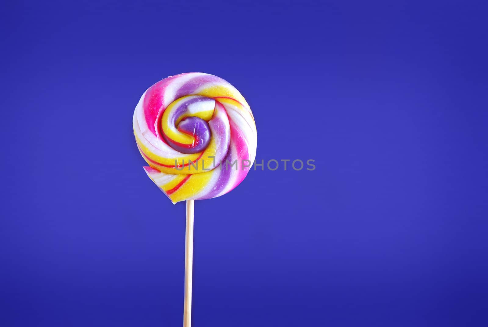 close-up of sweetie lillipop, isolated on blue background