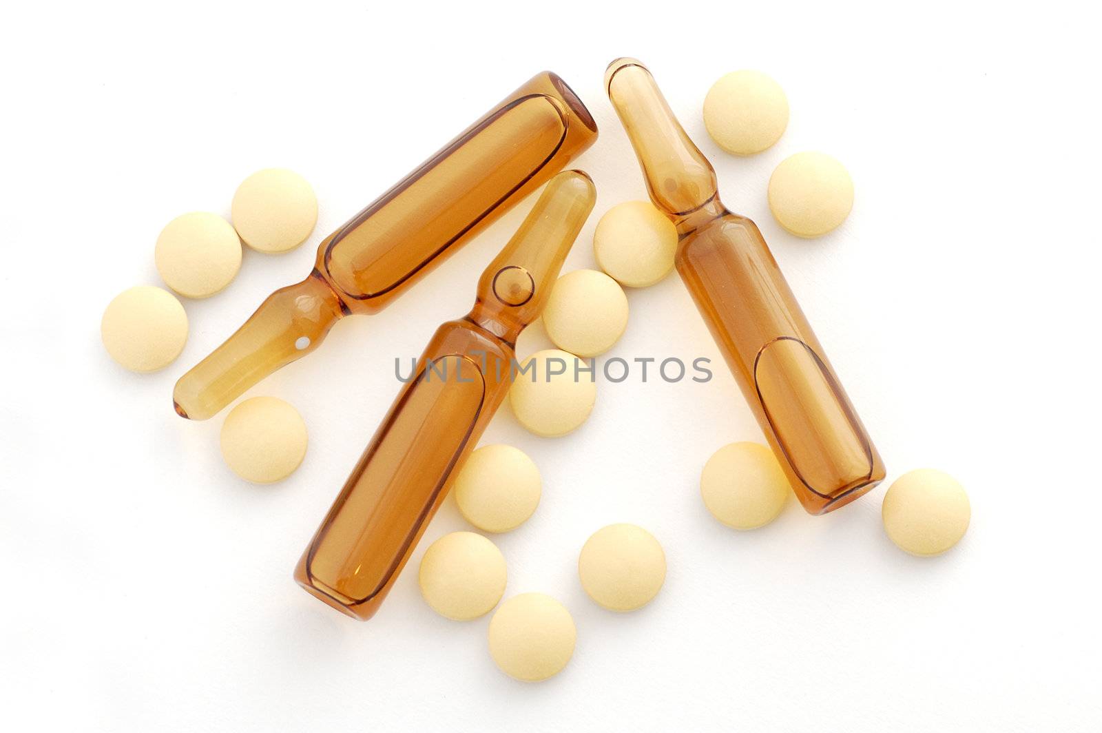 Pills and ampules on the white background