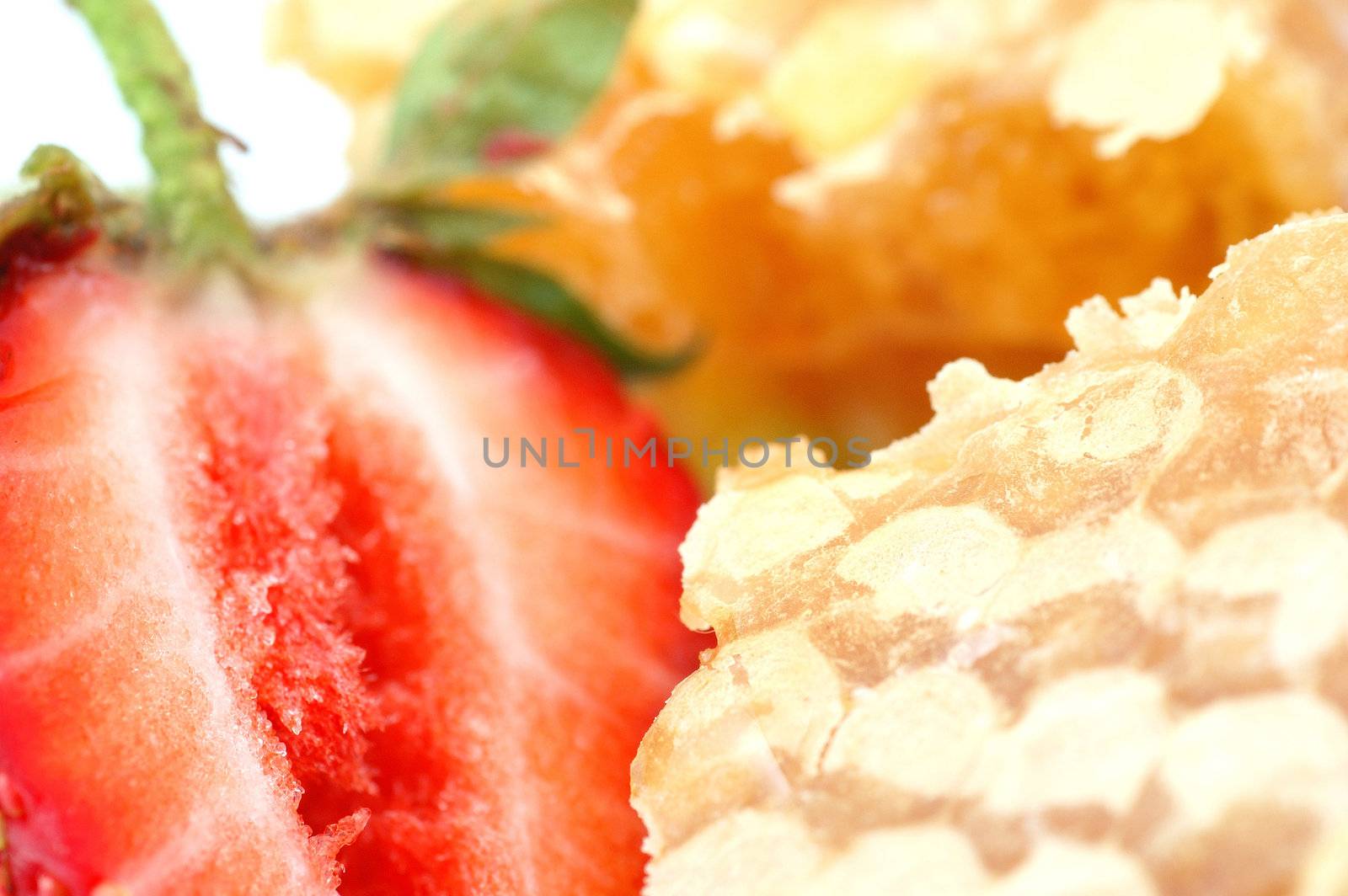 Piece of honey and strawberry close-up