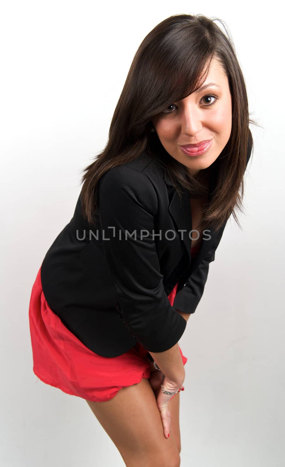 Pretty young woman posing in a studio with a nice black clothes