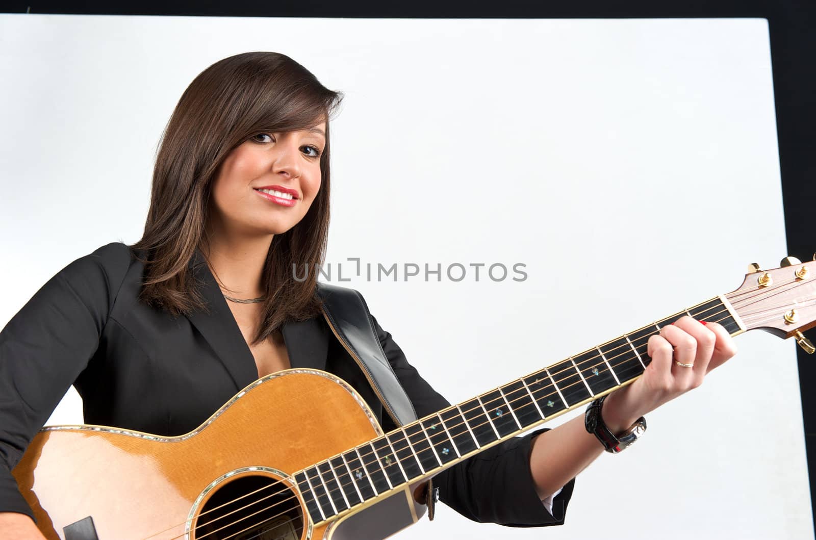 Pretty woman playing with guitar