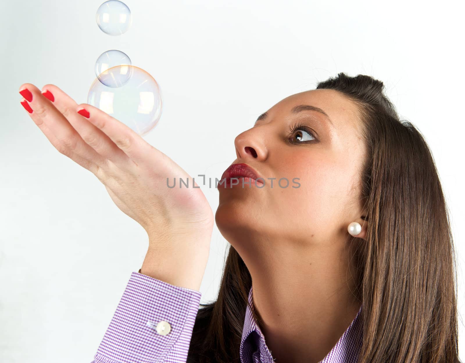 Pretty young woman posing with some bubbles around her