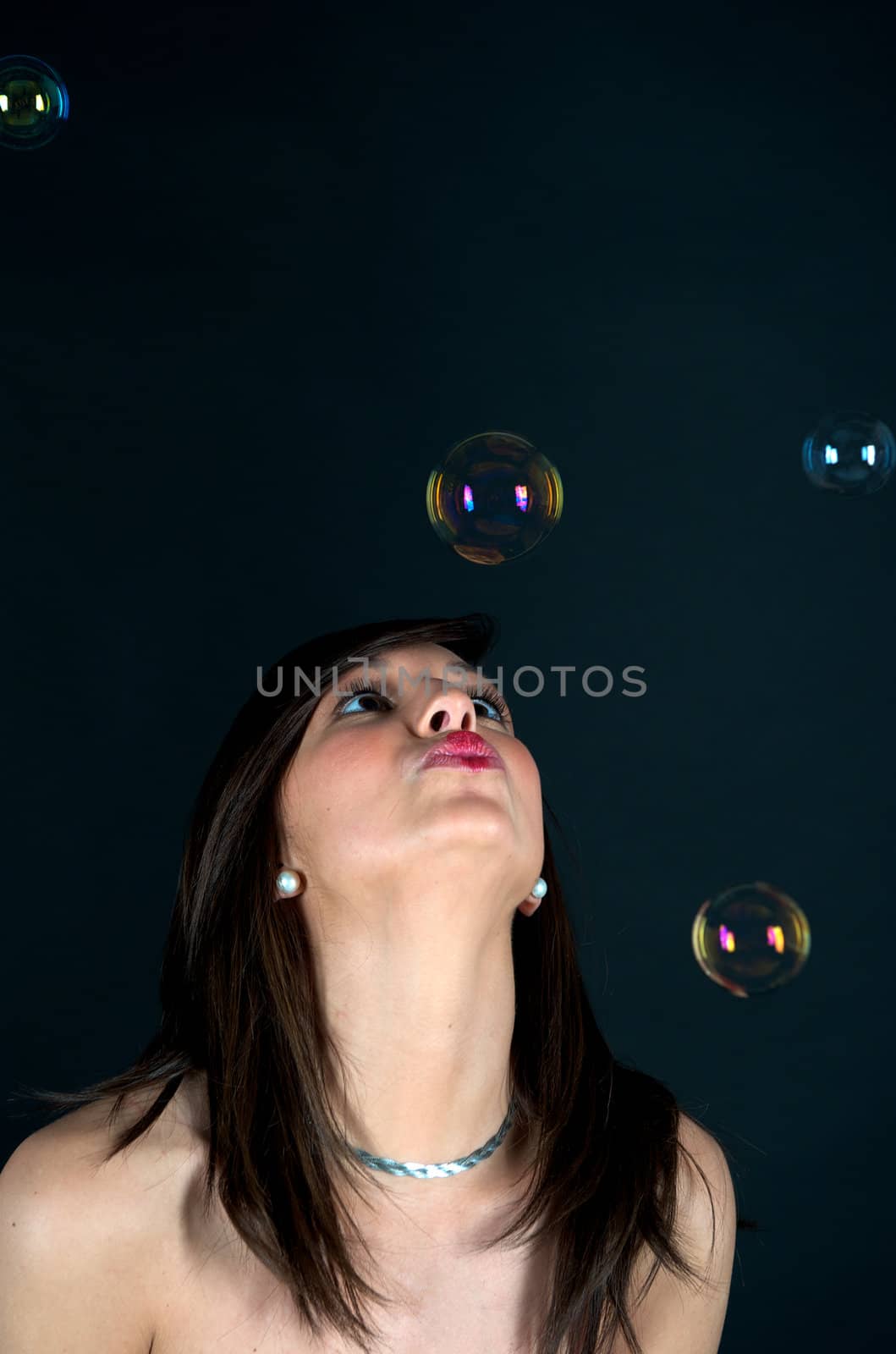 Pretty young woman posing with some bubbles around her