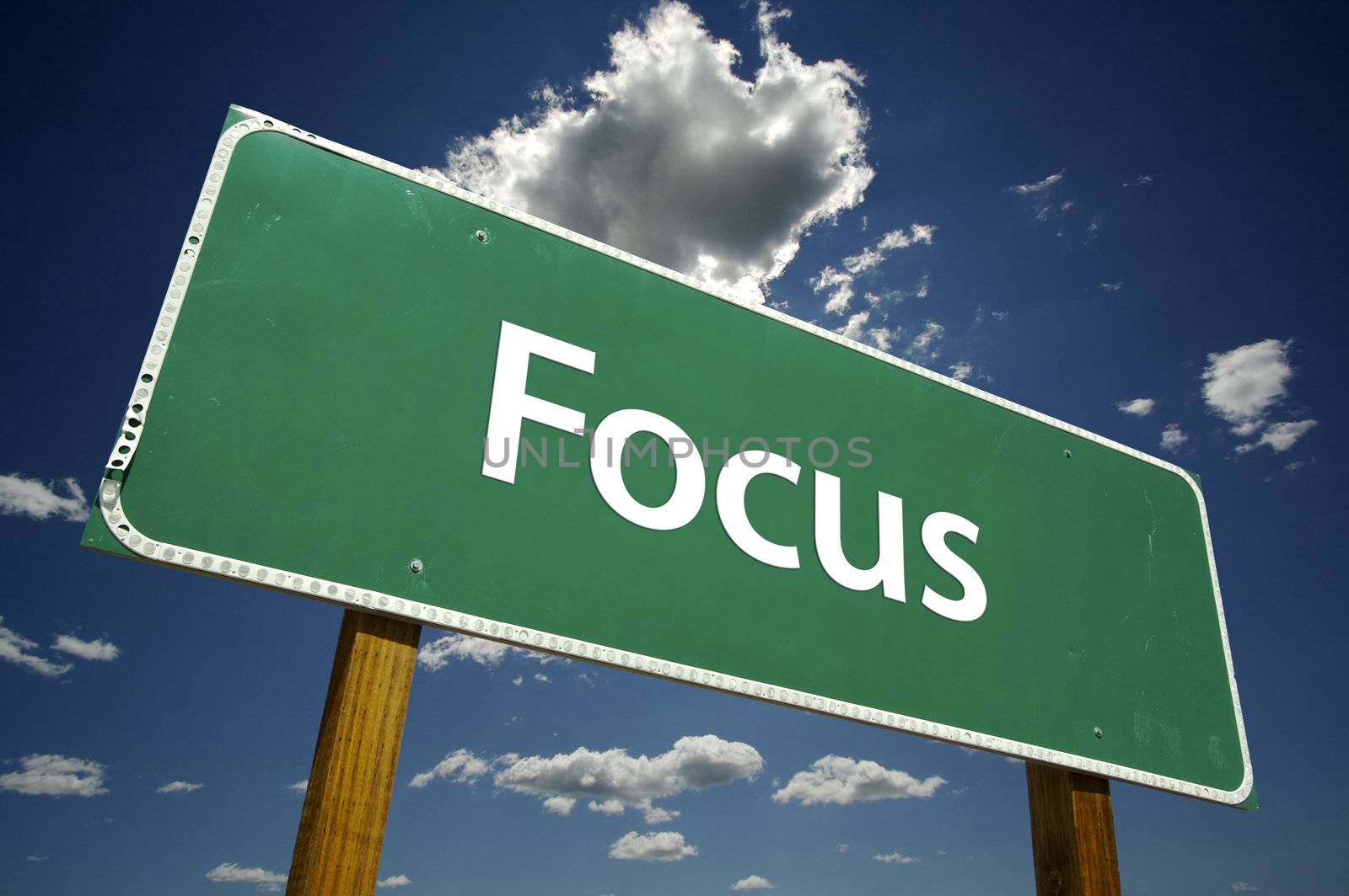 Focus road sign with dramatic blue sky and clouds.