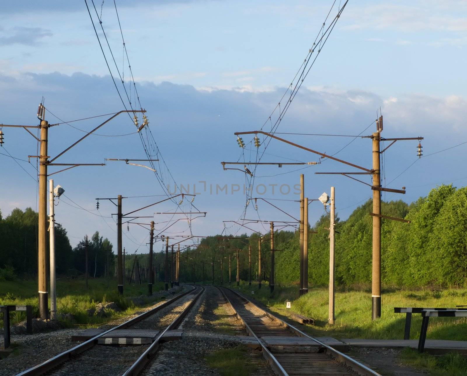 Straight railway track in summer sunrise