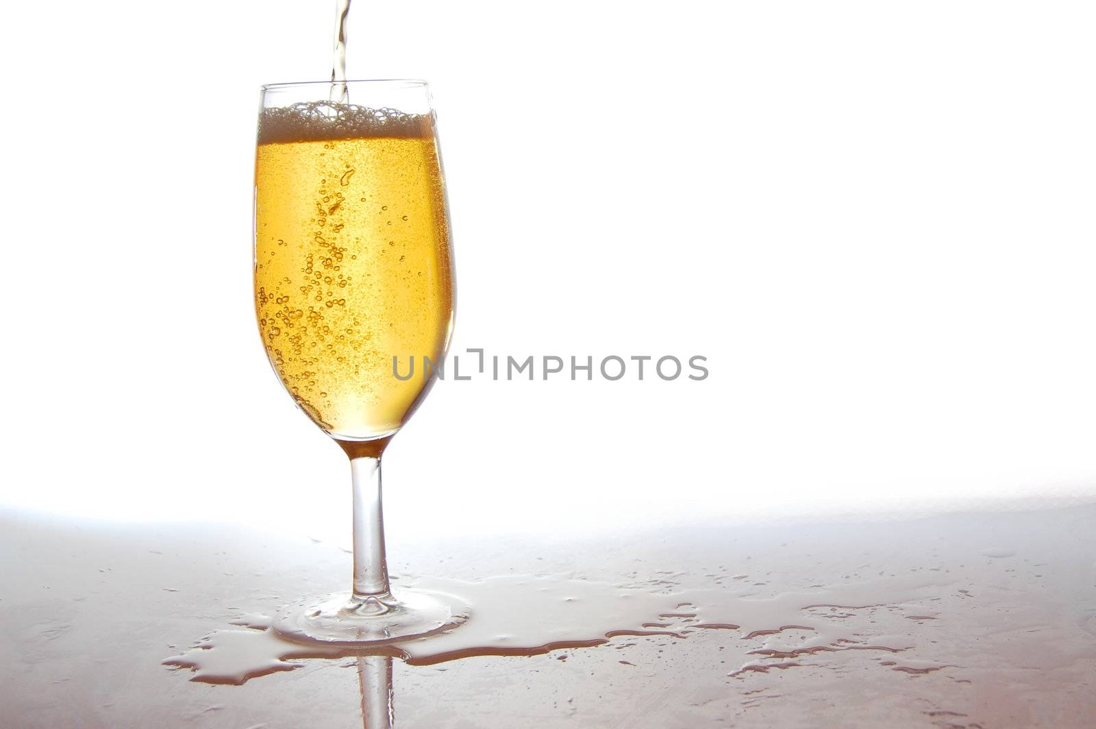 glass of fresh beer with bubbles on white