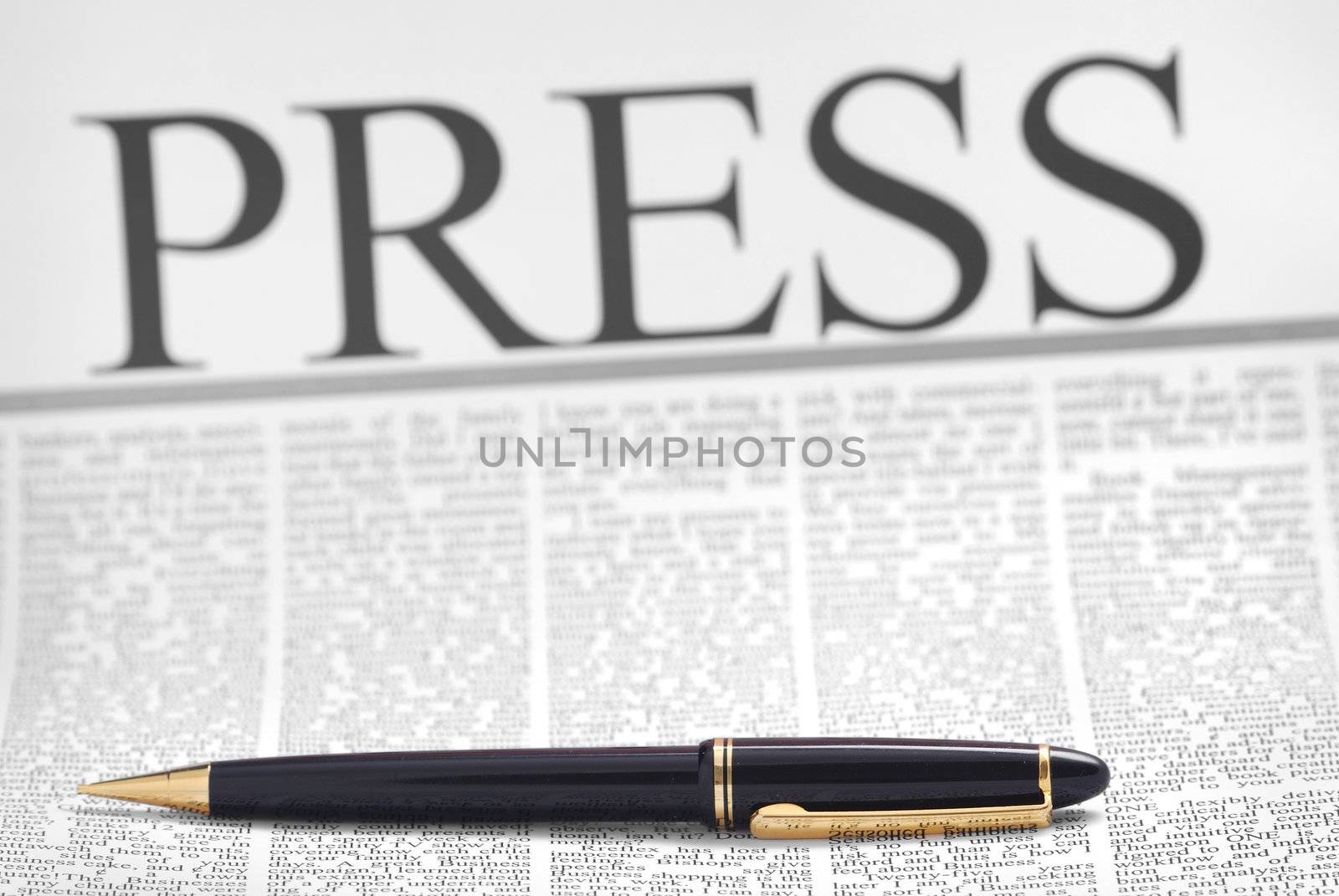 press headline, luxury pen on newspaper page