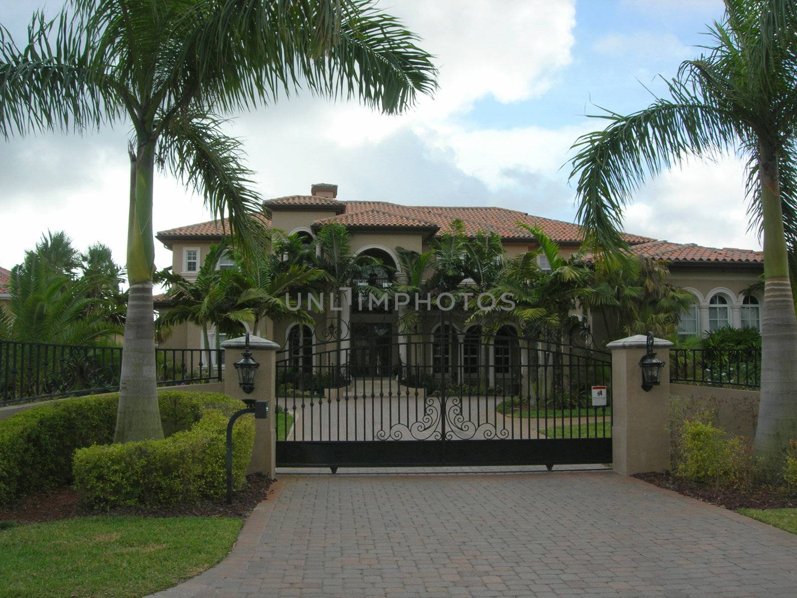   Mediterranean House with pavers, iron gate and lanscaping in miami florida        