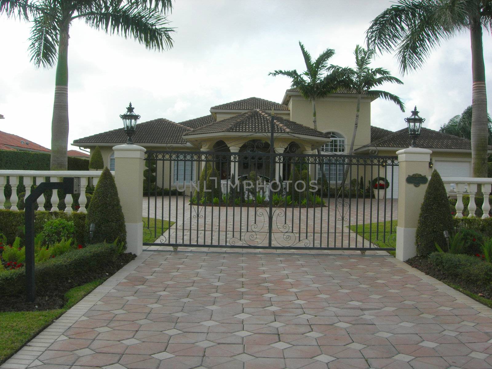   Mediterranean House with pavers, iron gate and landscaping        