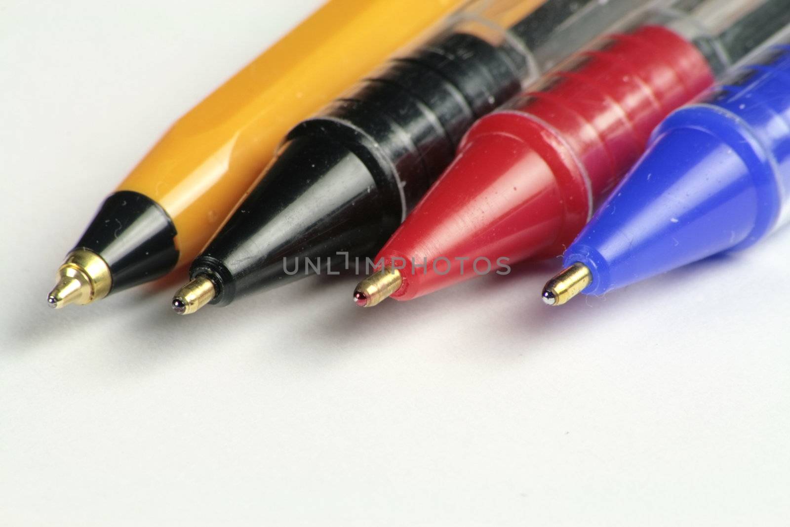 four different coloured ball point pens by leafy