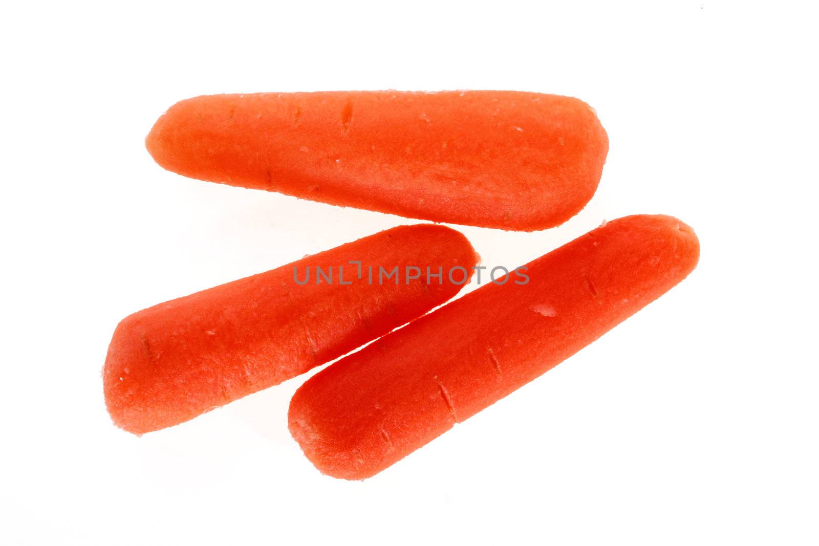 Three small carrots are isolated on a white background.