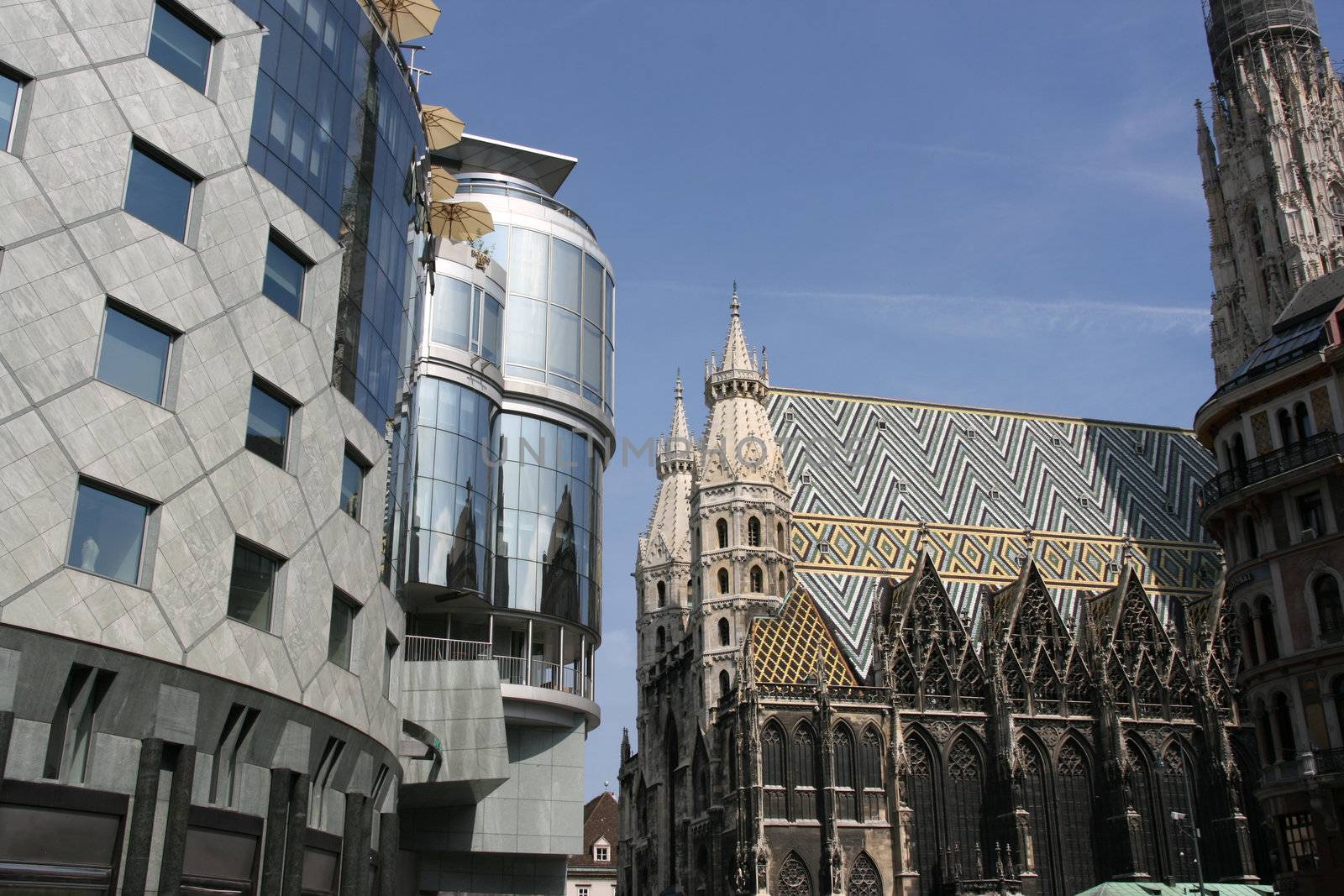 Contrast on Stephansplatz in Vienna (Austria) - new building of Haas Haus and old Gothic Cathedral (Stephansdom)