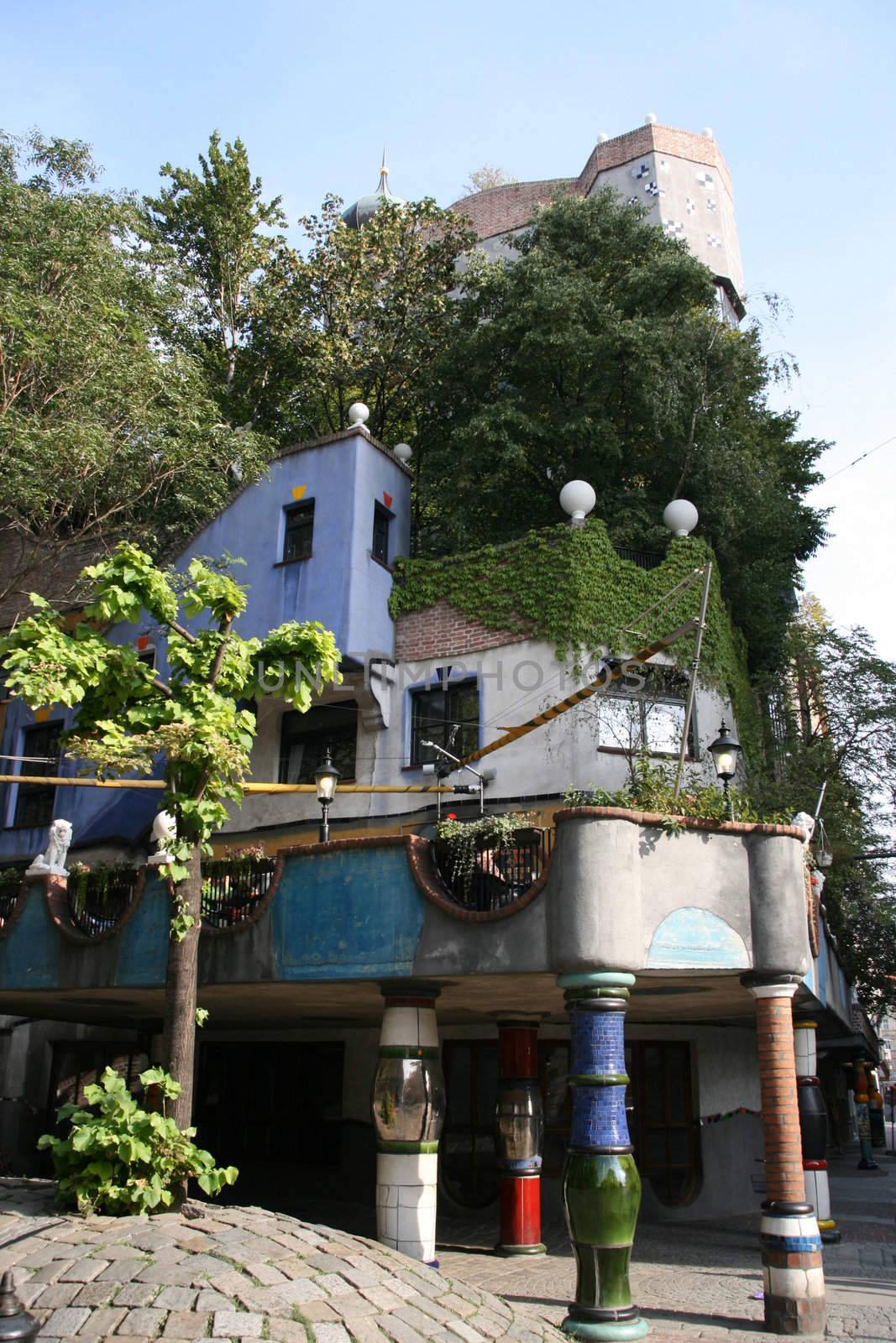 Hundertwasserhaus - famous extraordinary building in Vienna, Austria. Designed by Austrian artist Friedensreich Hundertwasser. Trees on roof.